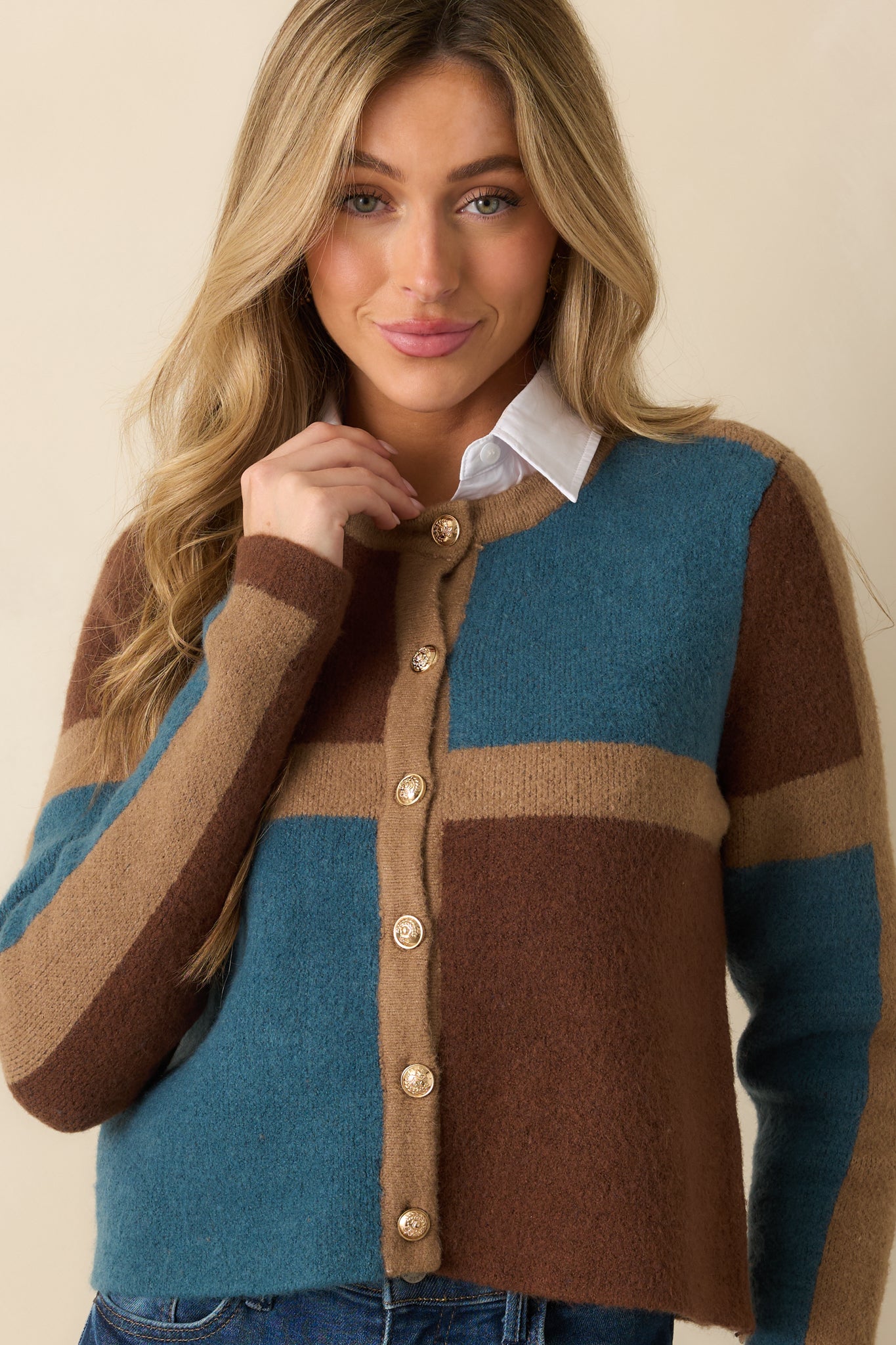 Cropped view highlighting the transition between brown, camel, and teal color blocks and the soft knit texture.