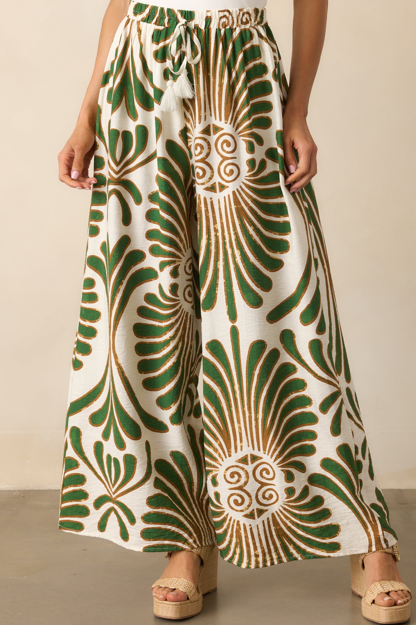 Cropped view of the lower pant legs, highlighting the wide leg cut and how the print flows toward the hem.