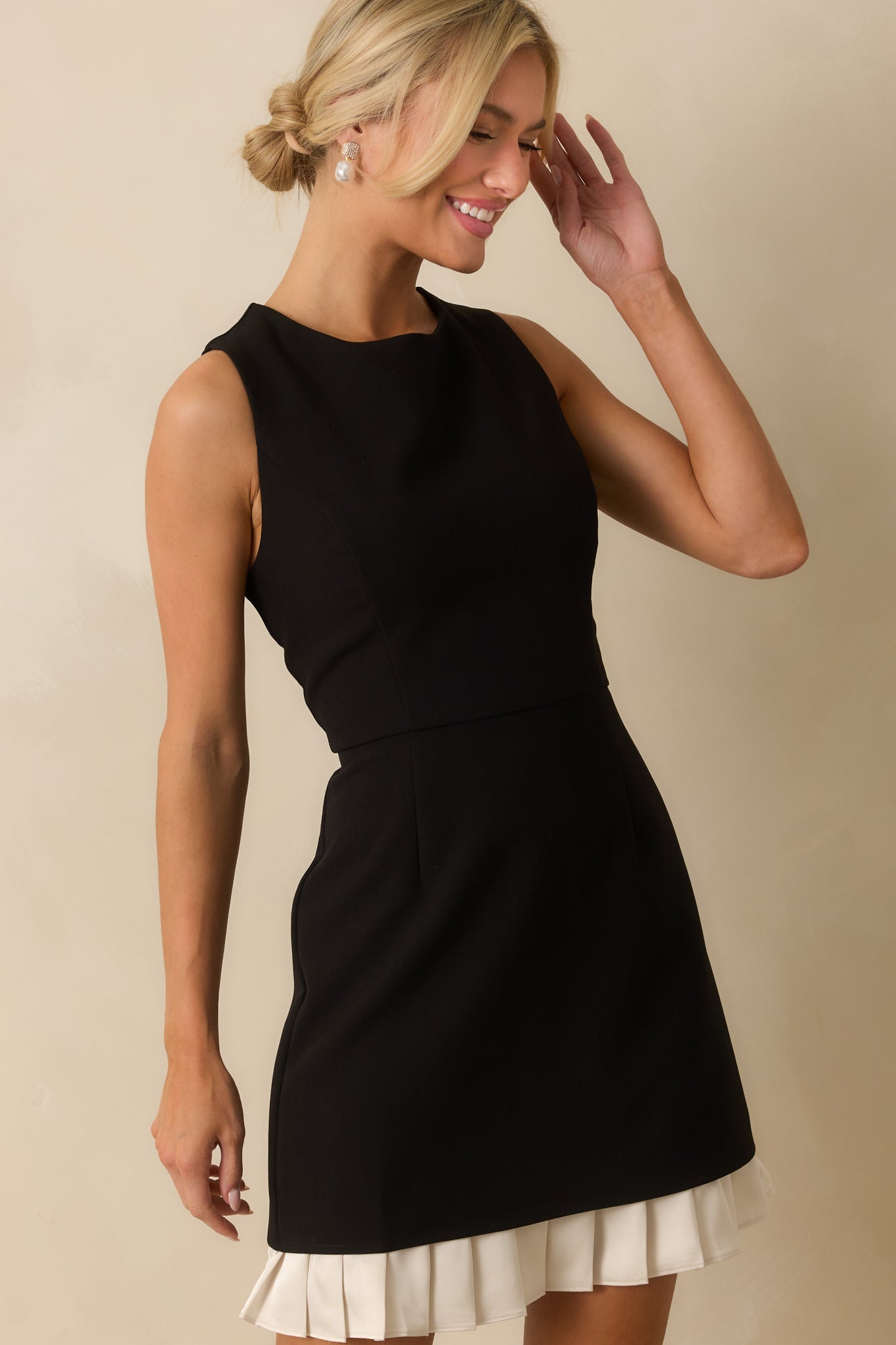 Cropped view highlighting the ivory pleated ruffle hem and smooth fabric.