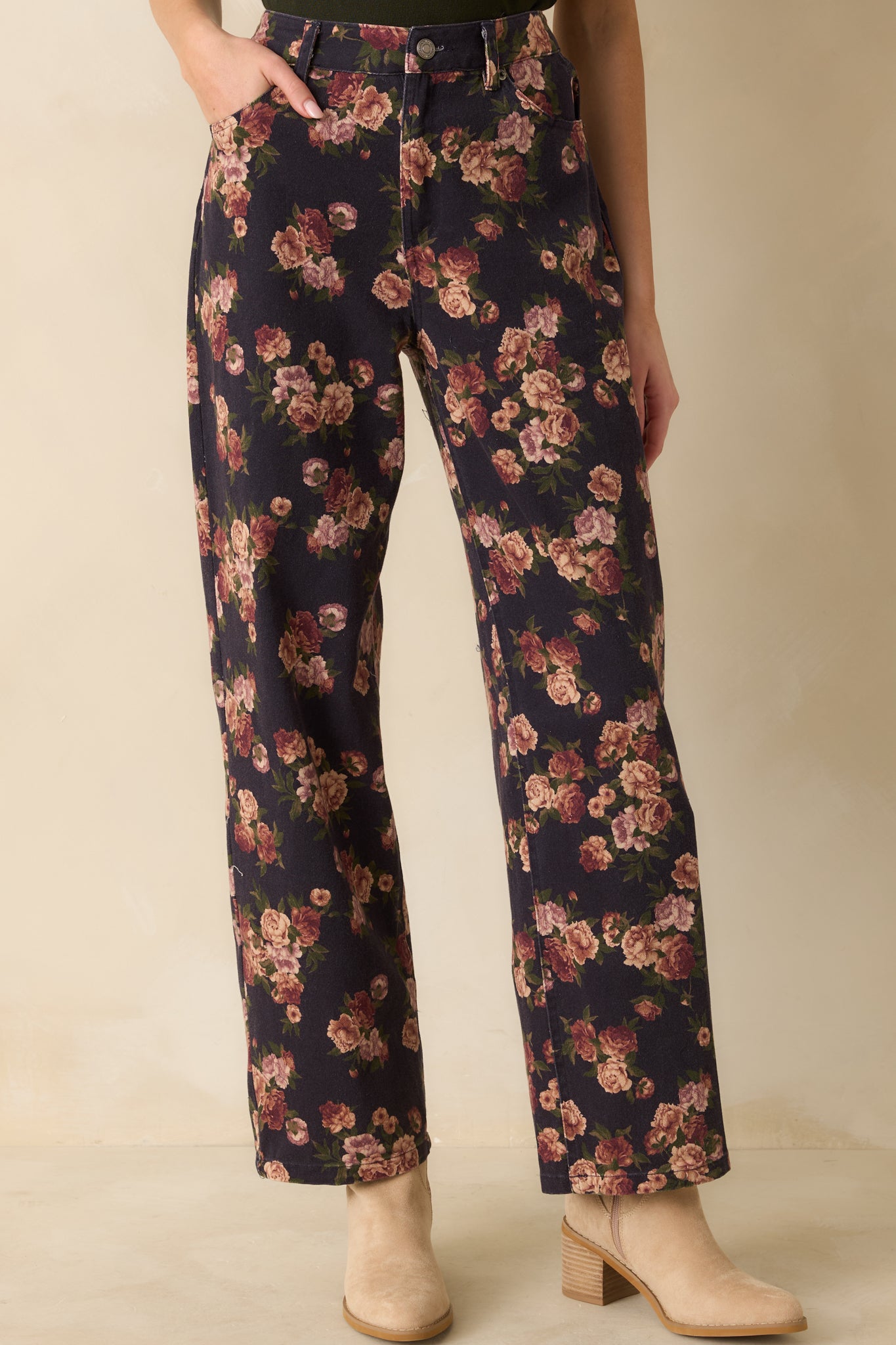 Cropped view of the jeans’ upper front, emphasizing functional pockets and floral print.