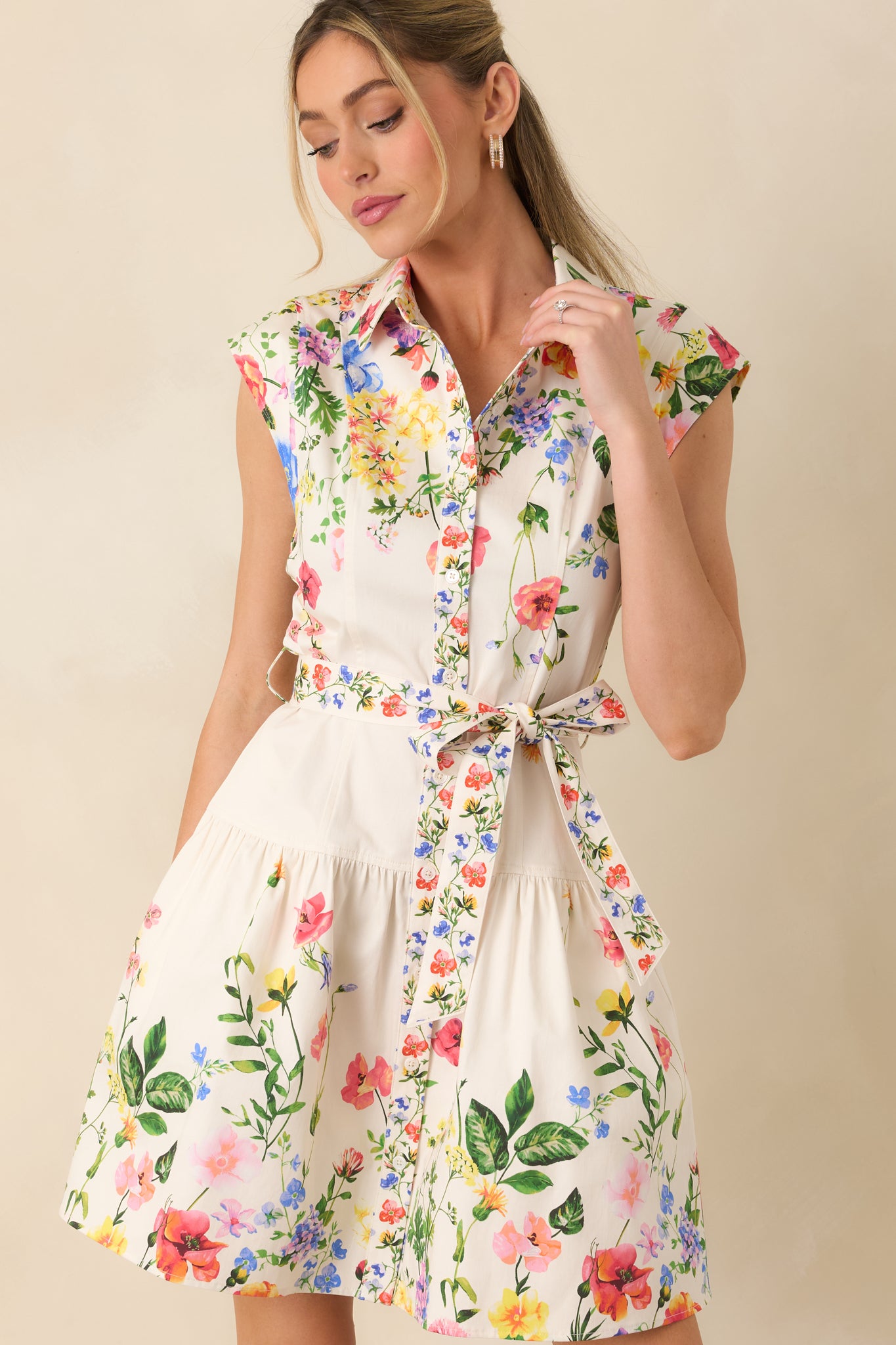 Detailed cropped shot of the mini dress emphasizing the lightweight cotton fabric and soft floral pattern.