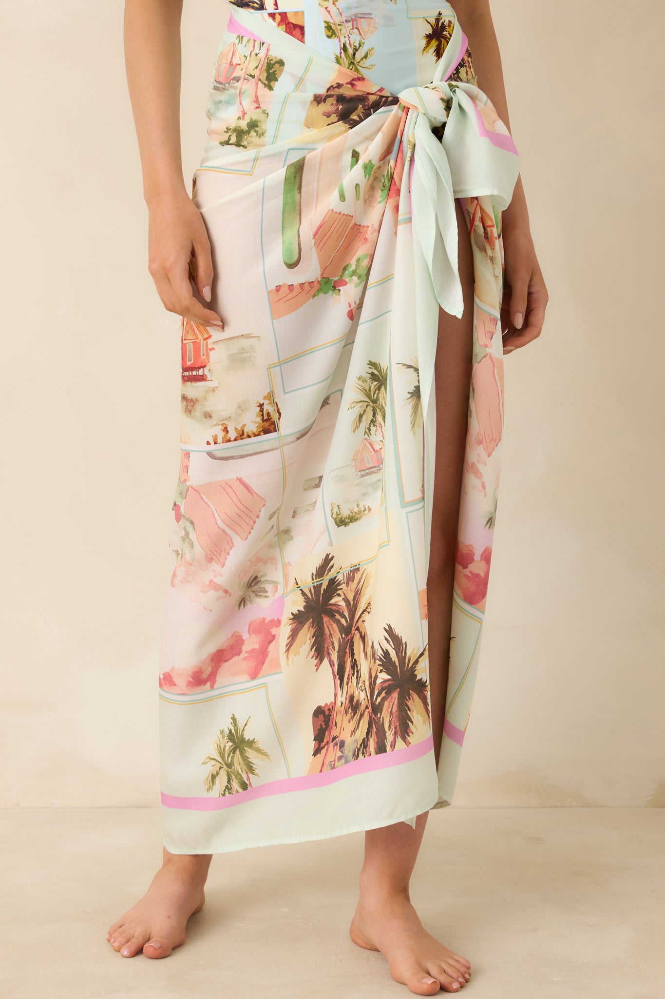 Cropped view of postcard print sarong highlighting side tie detail and draped wrap design
