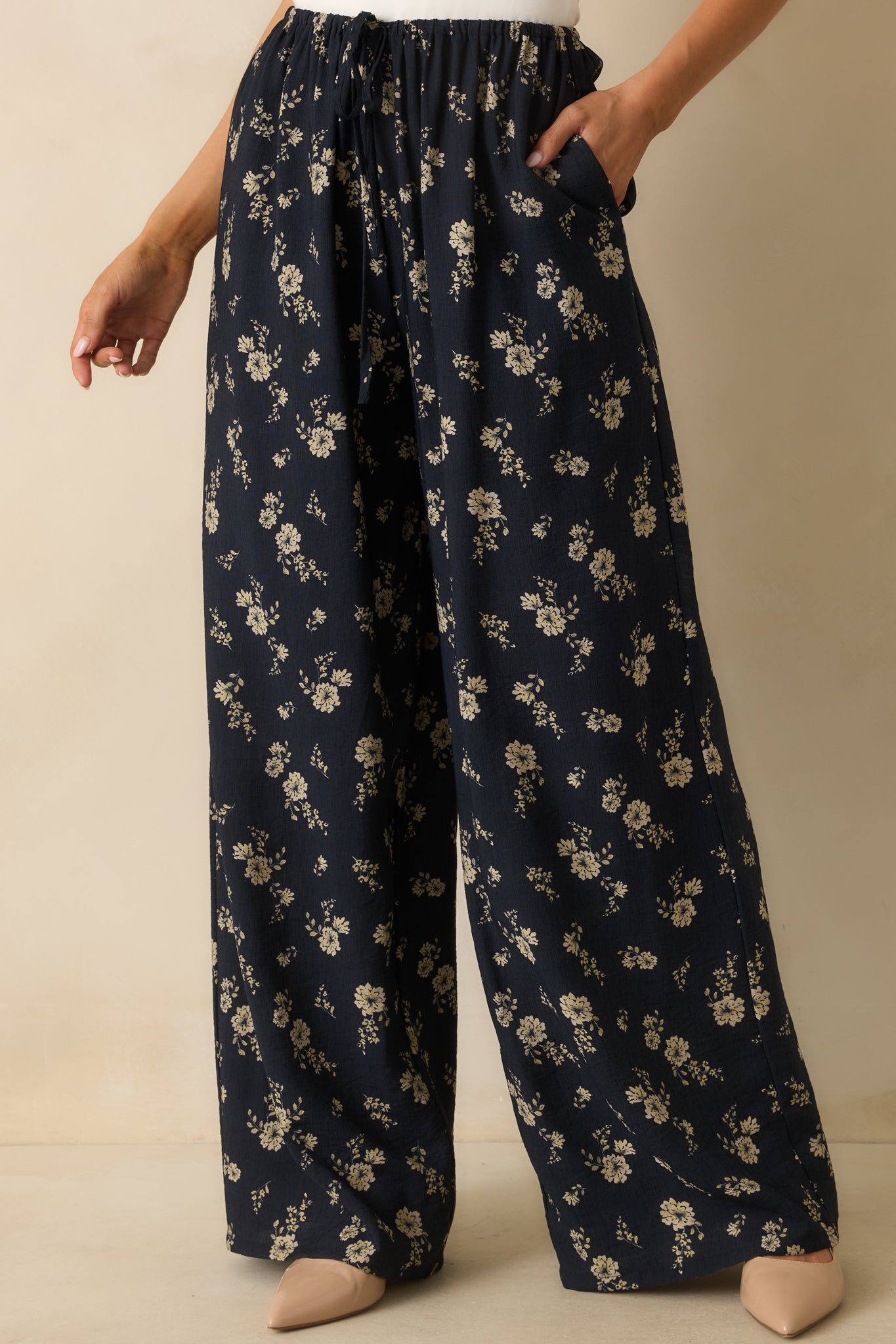 Cropped view of the pants, focusing on the high-rise waist and elastic waistband.