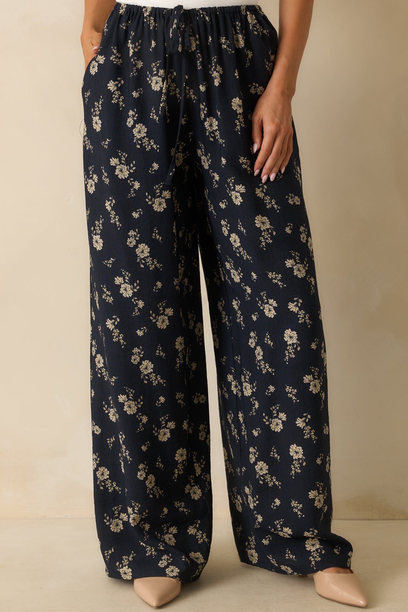 Cropped view of the pants, focusing on the high-rise waist and elastic waistband.