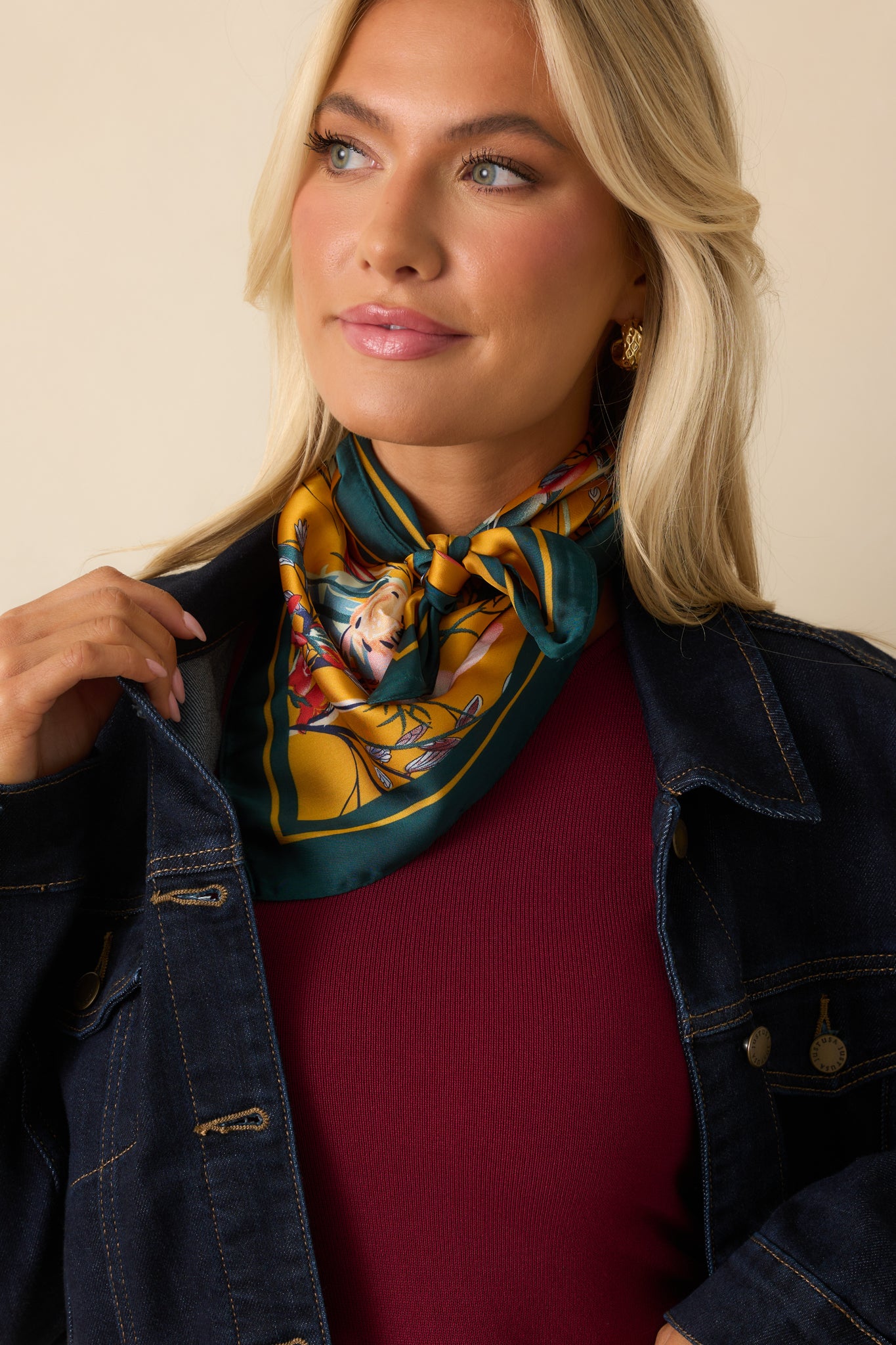 A cropped view of the scarf highlighting the green border and detailed floral motifs.