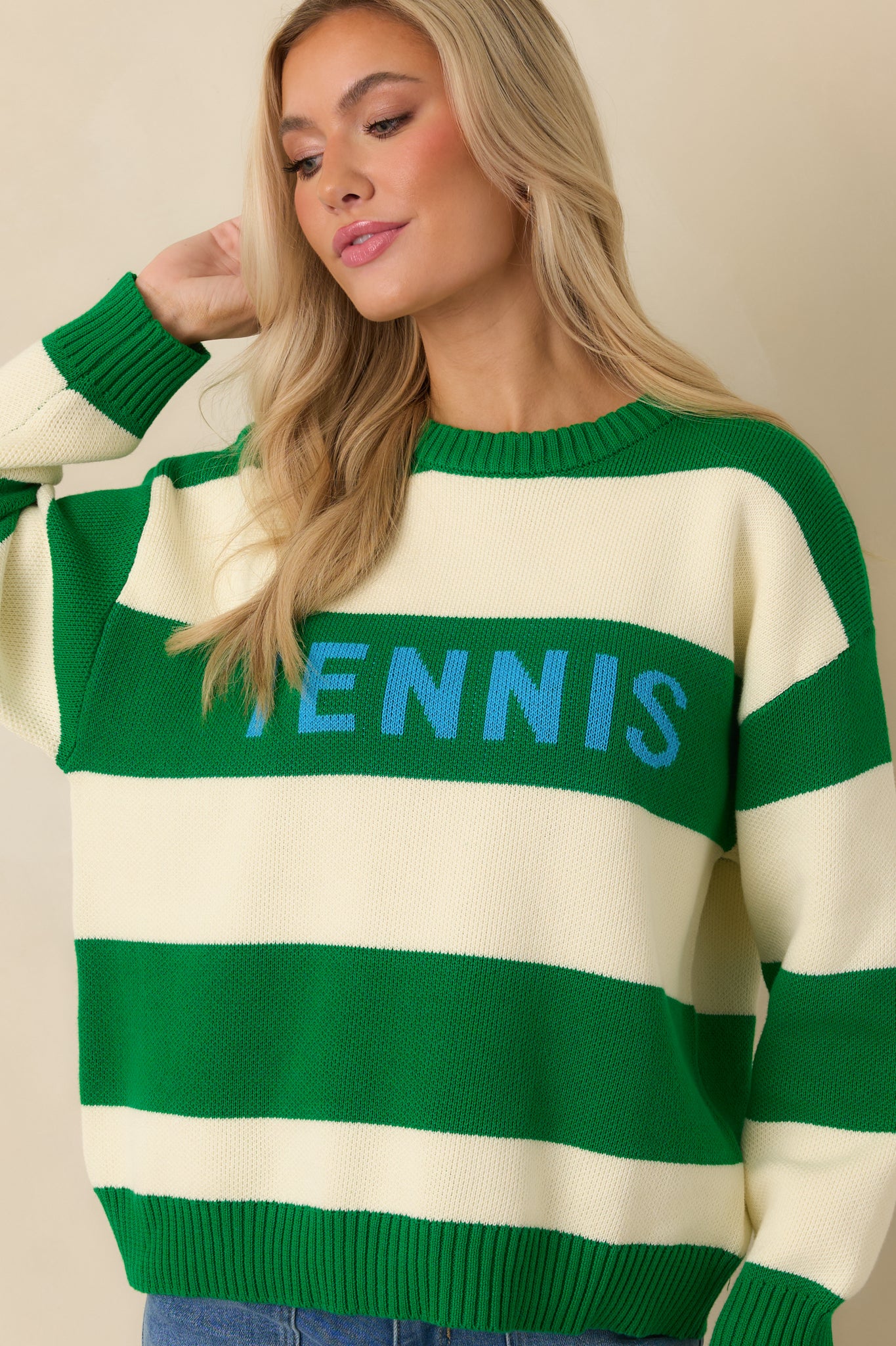 Cropped view showing the ribbed cuffs and midweight knit fabric on the striped sweater.