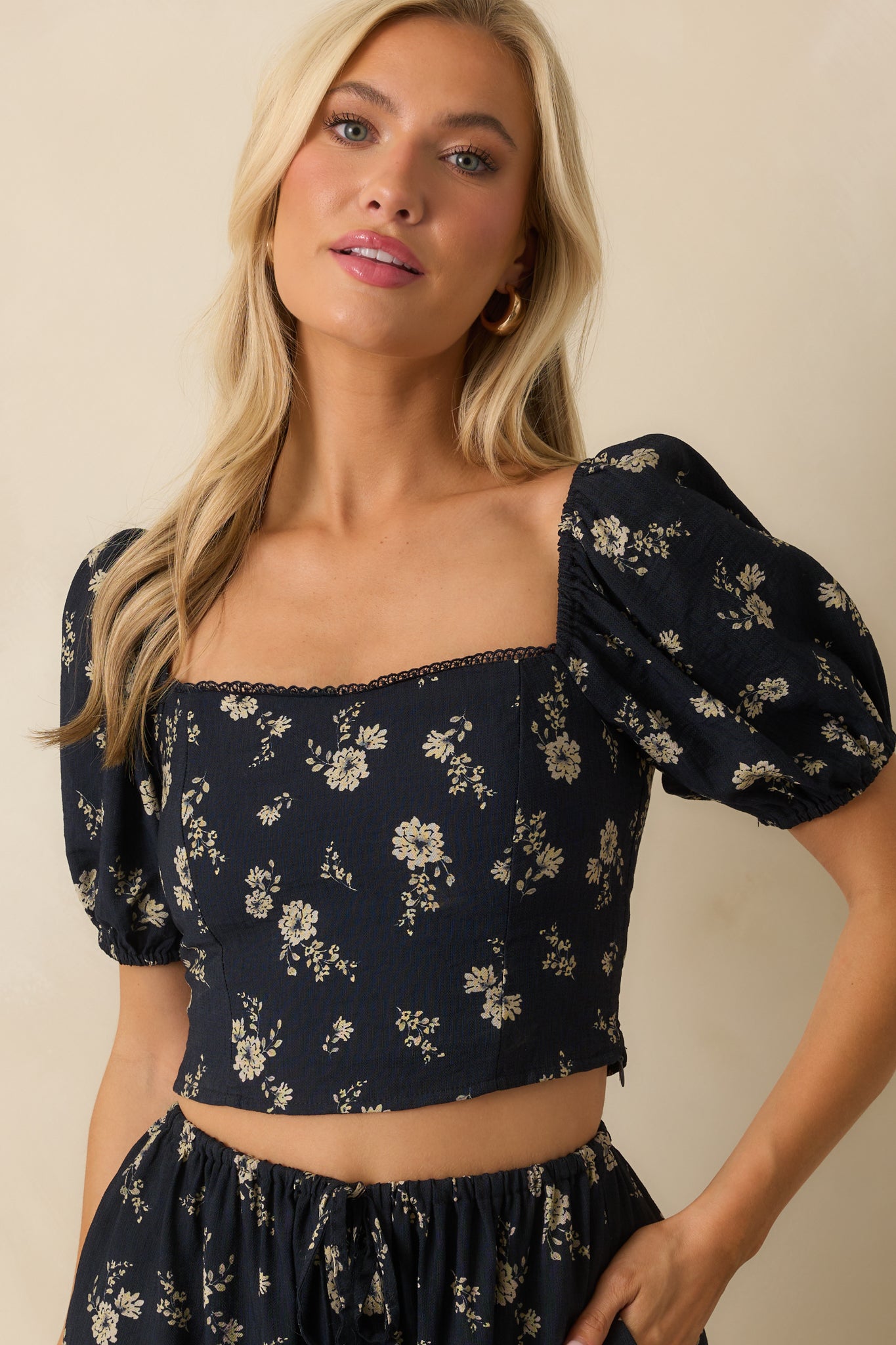 Cropped view of the top, focusing on the scalloped lace trim along the neckline.