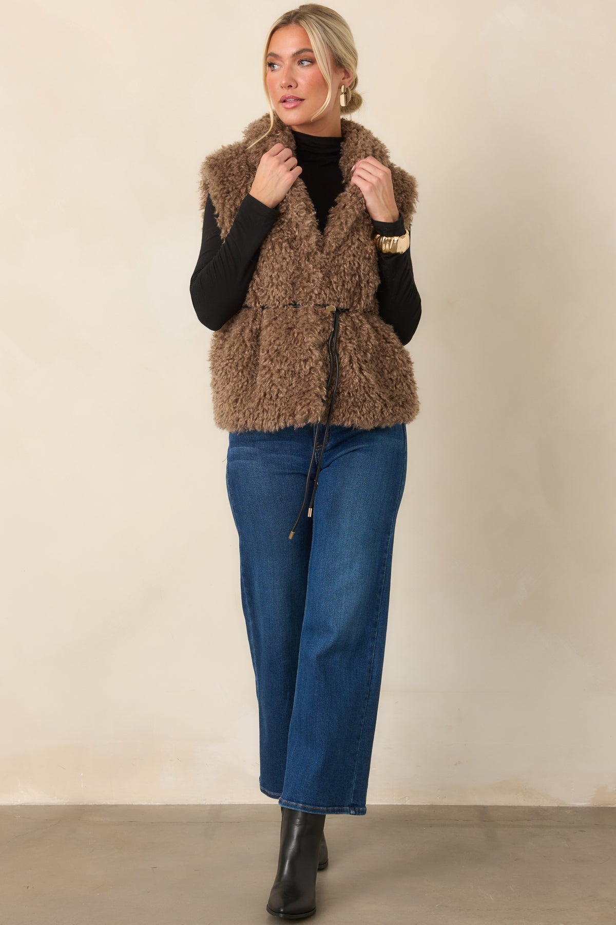 Curly faux fur vest with a vintage-inspired texture, oversized shawl collar, and defined waist belt.