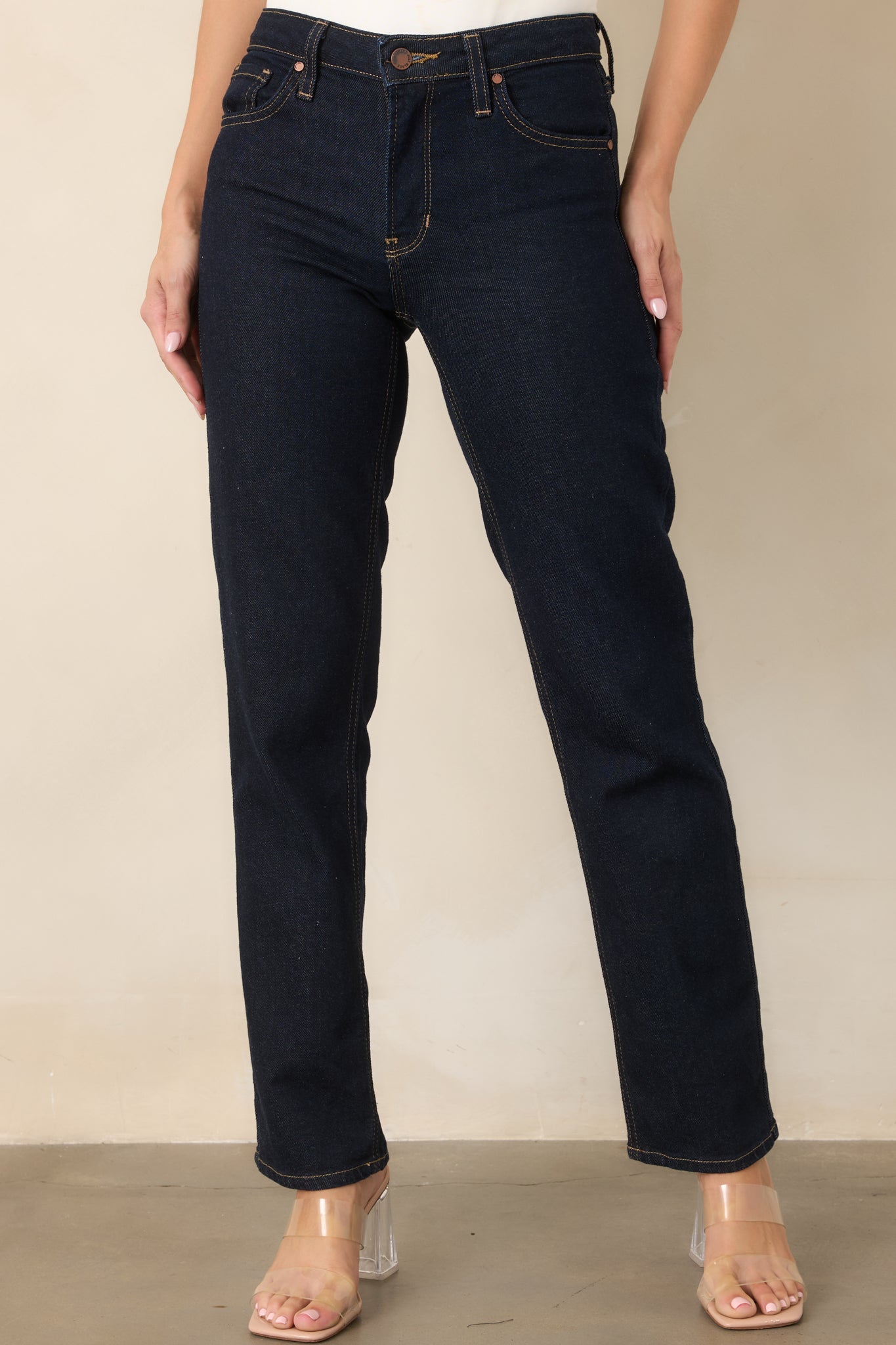 Dark blue denim detail showcasing the traditional five-pocket design and smooth structured construction.