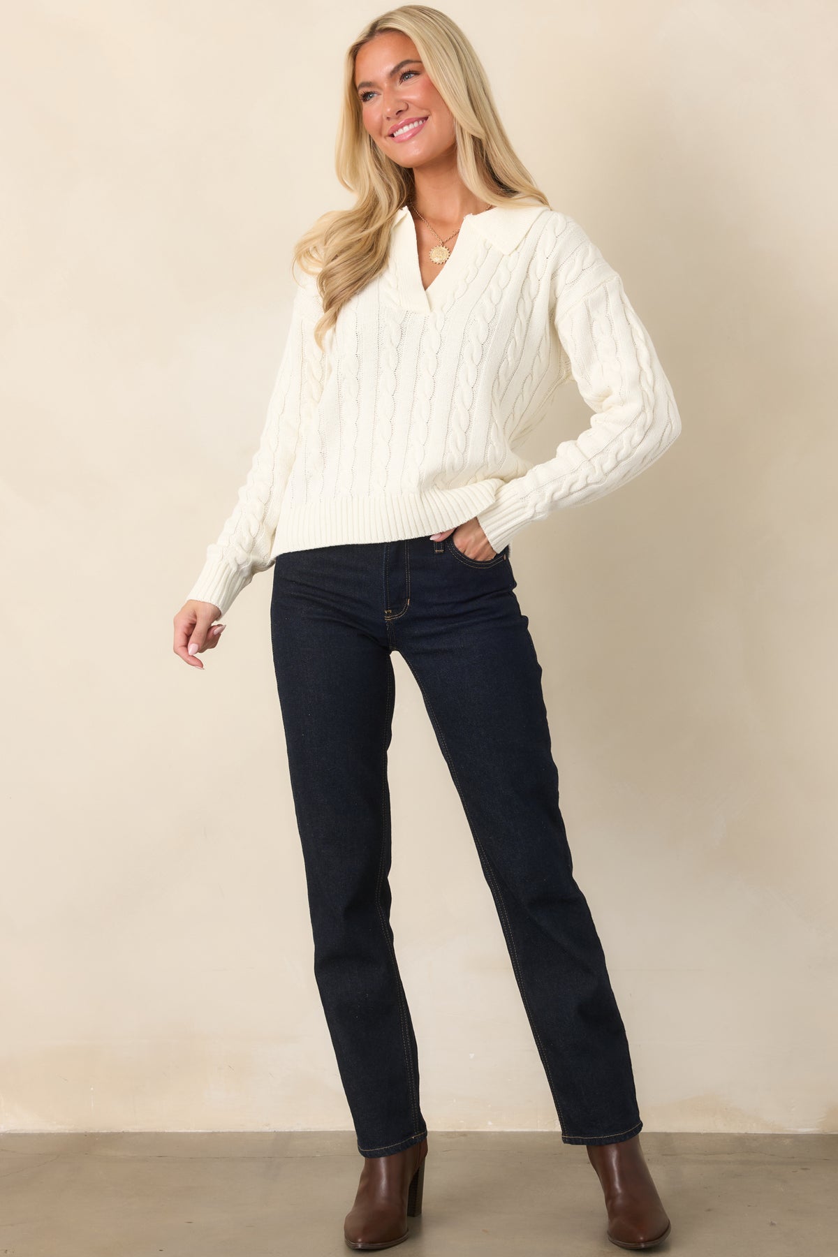 Dark blue denim jeans showcasing a streamlined straight-leg silhouette, high-rise waist, traditional pockets, and functional belt loops.
