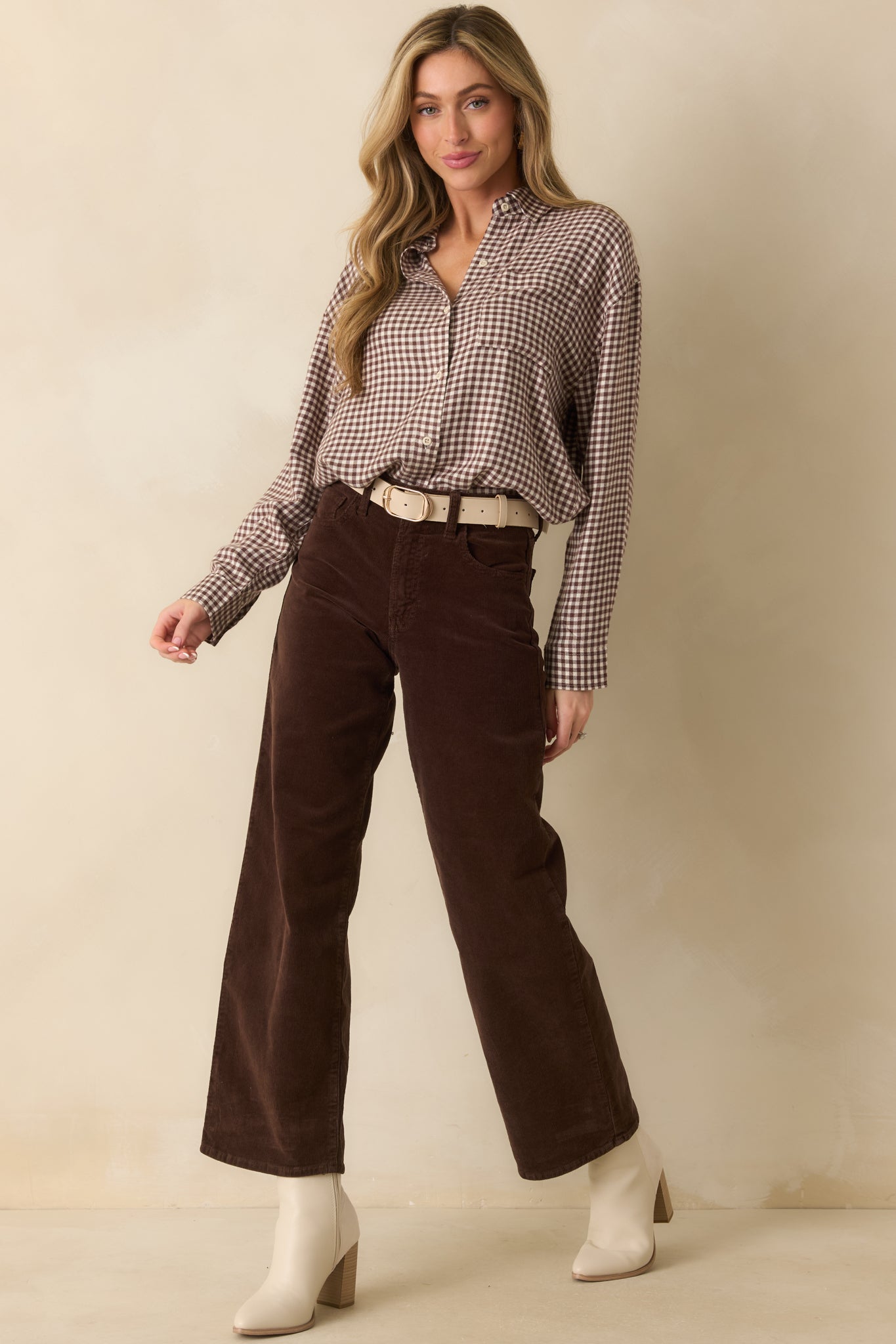 Full body front view of dark brown corduroy pants with wide-leg silhouette, high-rise waist, and functional pockets.