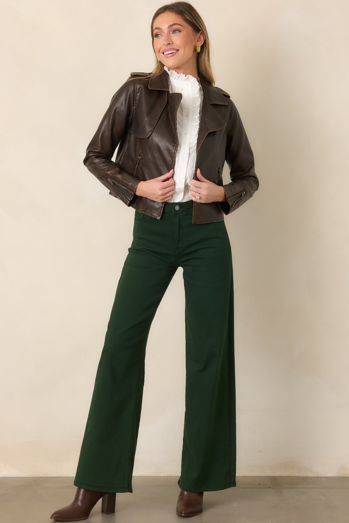 Dark brown faux leather jacket showcasing the cropped length, wide notched lapels, long sleeves, and sleek open-front design.