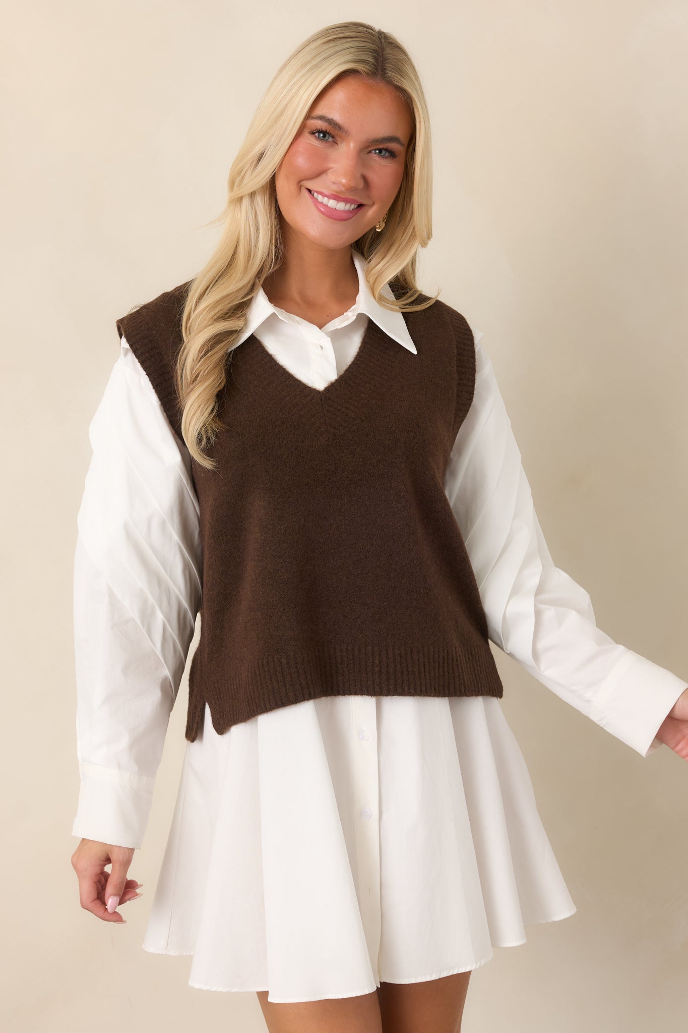 Detailed view of the rich chocolate vest showcasing the wide ribbed V-neck trim and streamlined front silhouette.