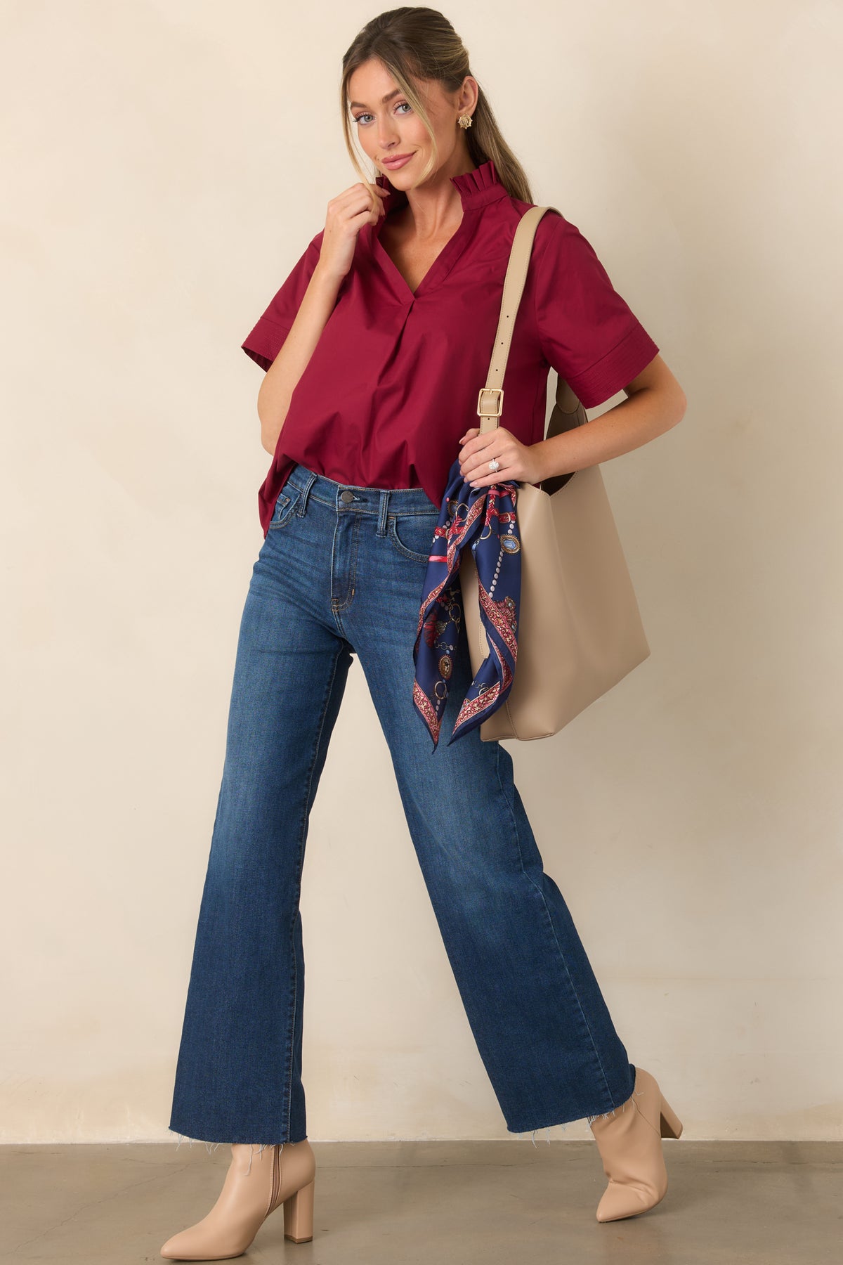Dark denim pants designed with a high-rise fit, straight legs, belt loops, and functional front and back pockets.