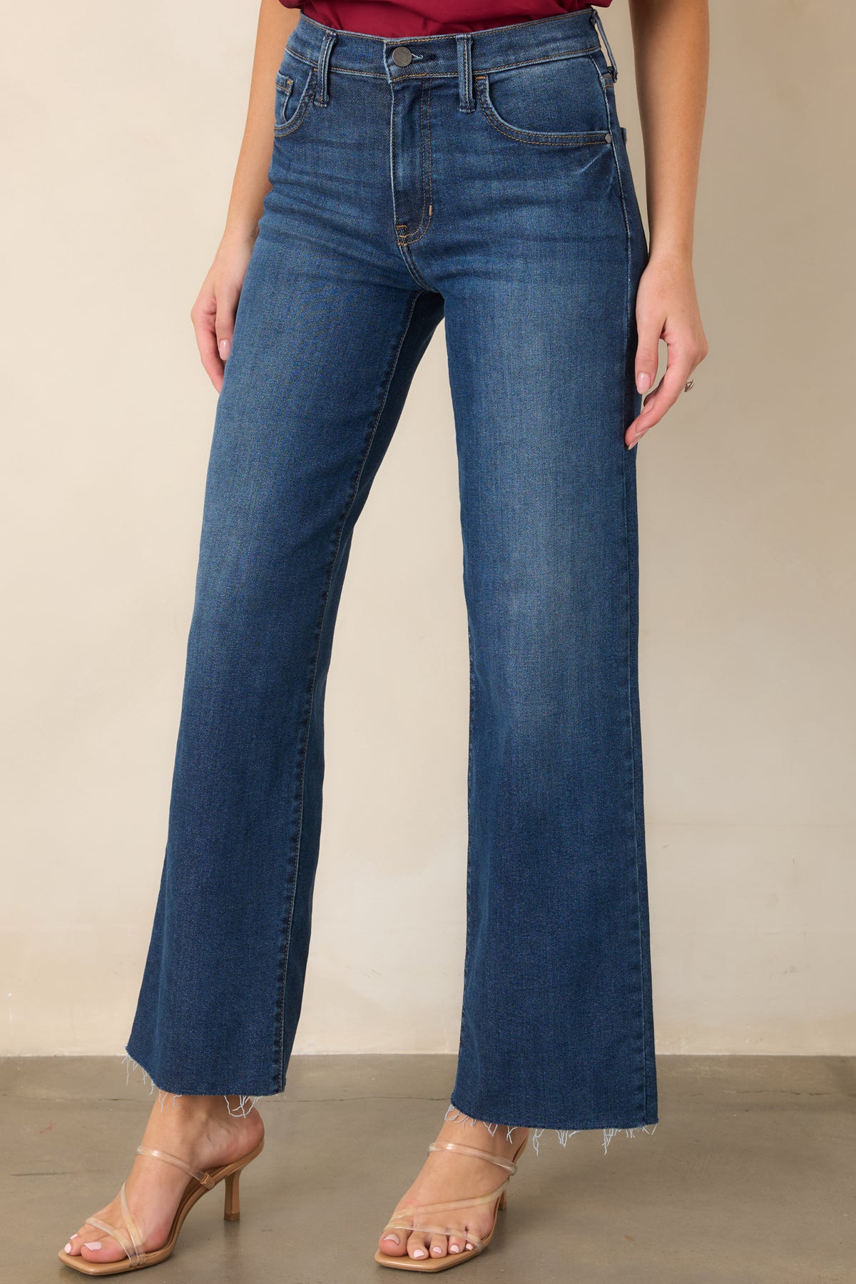 Dark denim showcasing the smooth front closure, structured waistband, and classic five-pocket construction.