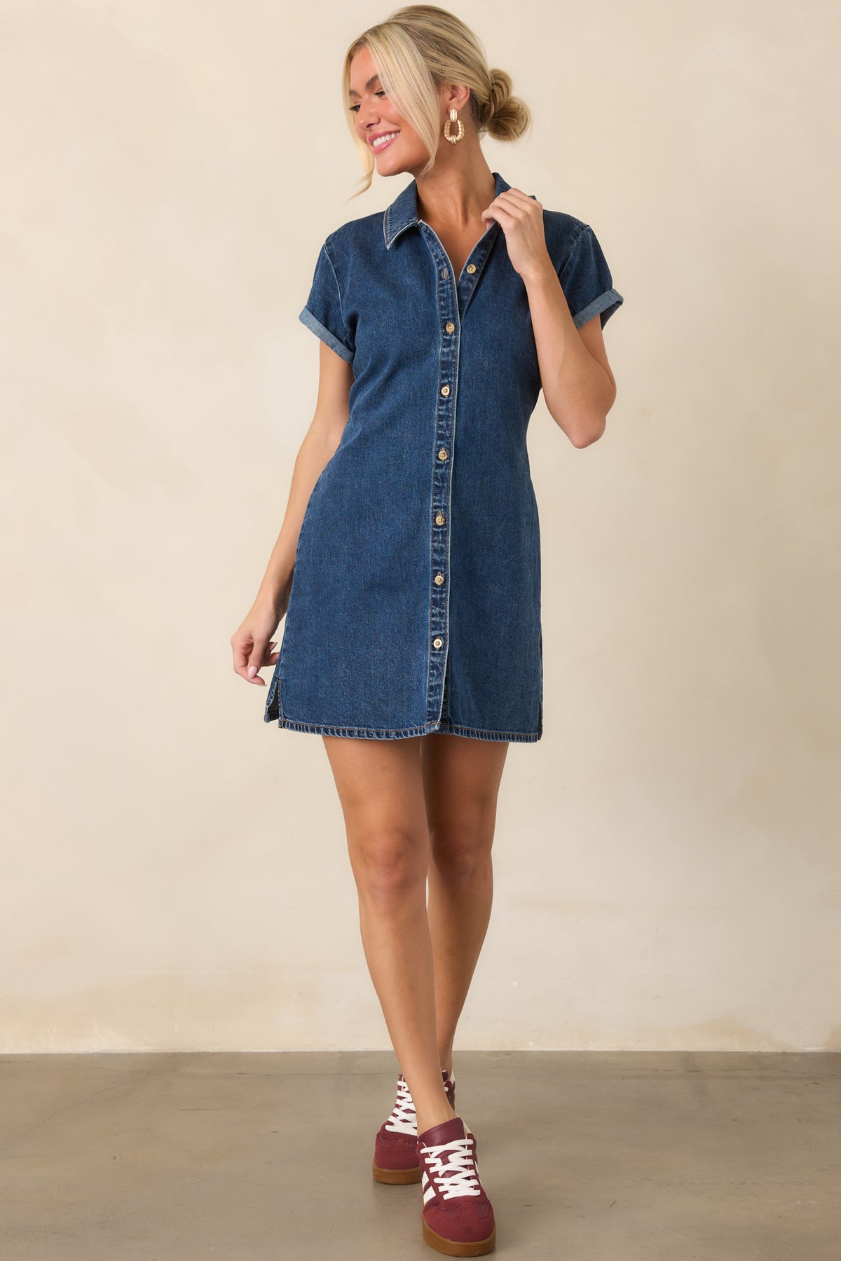 Dark indigo denim mini dress featuring a pointed collar and button front.