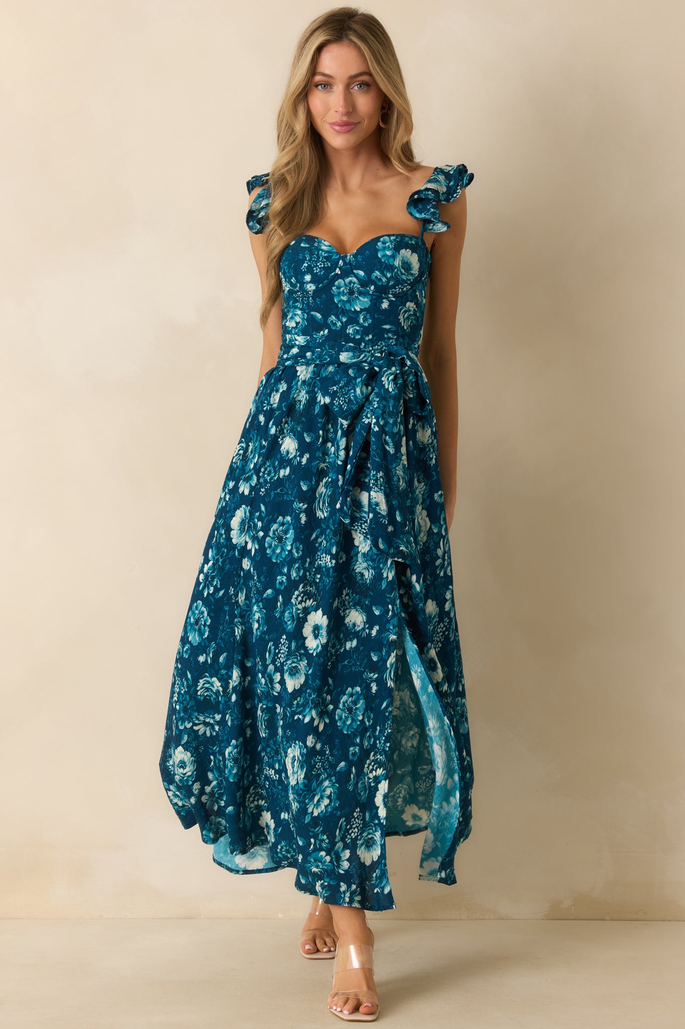 Dark teal maxi dress with a multicolor floral print, sweetheart neckline, and corset-style front bodice with boning.