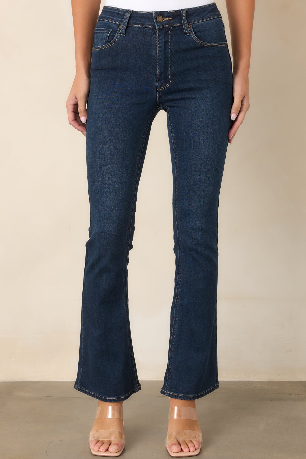 Cotton-blend dark denim jeans with a high-rise waist and gently flared leg.