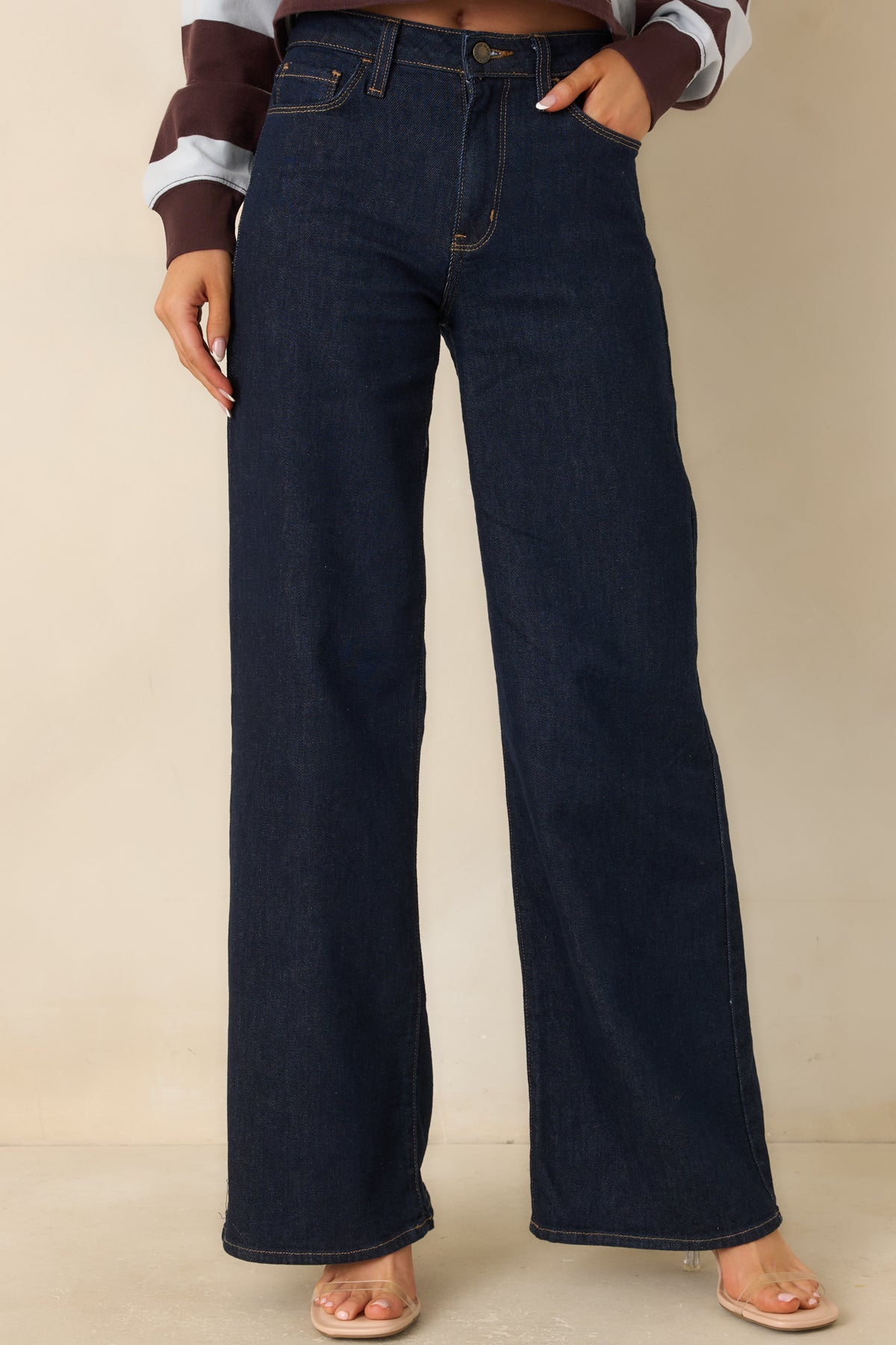 Dark wash denim highlighting the high-rise waistband and smooth finish.