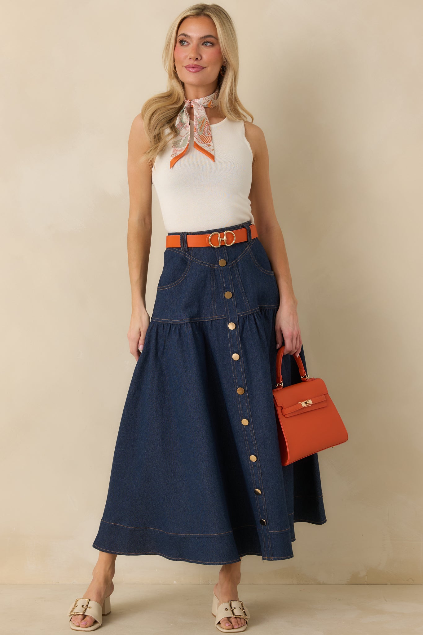 Full-length view of the dark wash denim maxi skirt highlighting the high-rise waist and button-front closure.