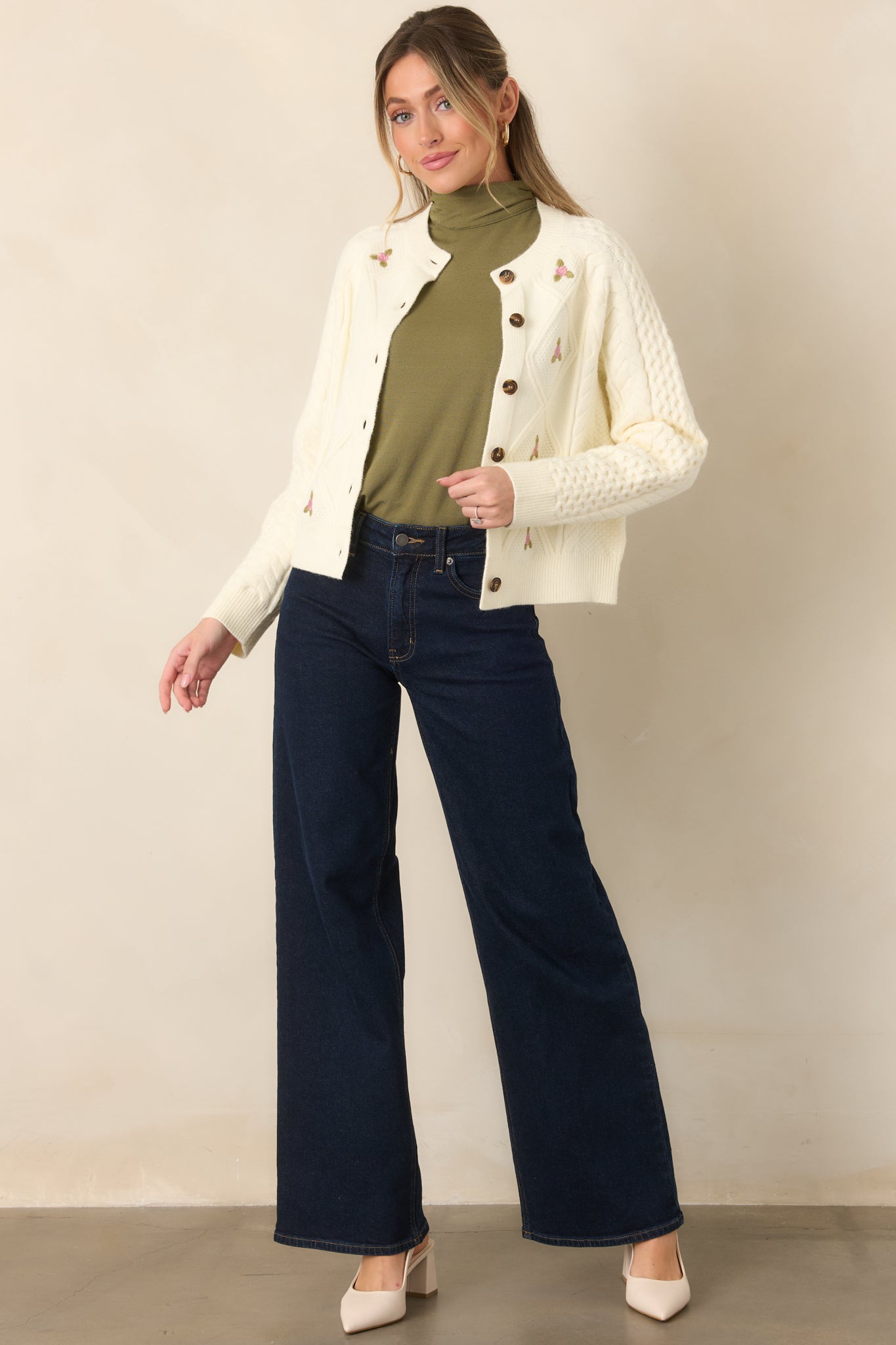 Dark wash denim pants featuring a high-rise fit, full-length wide legs, and classic five-pocket styling.