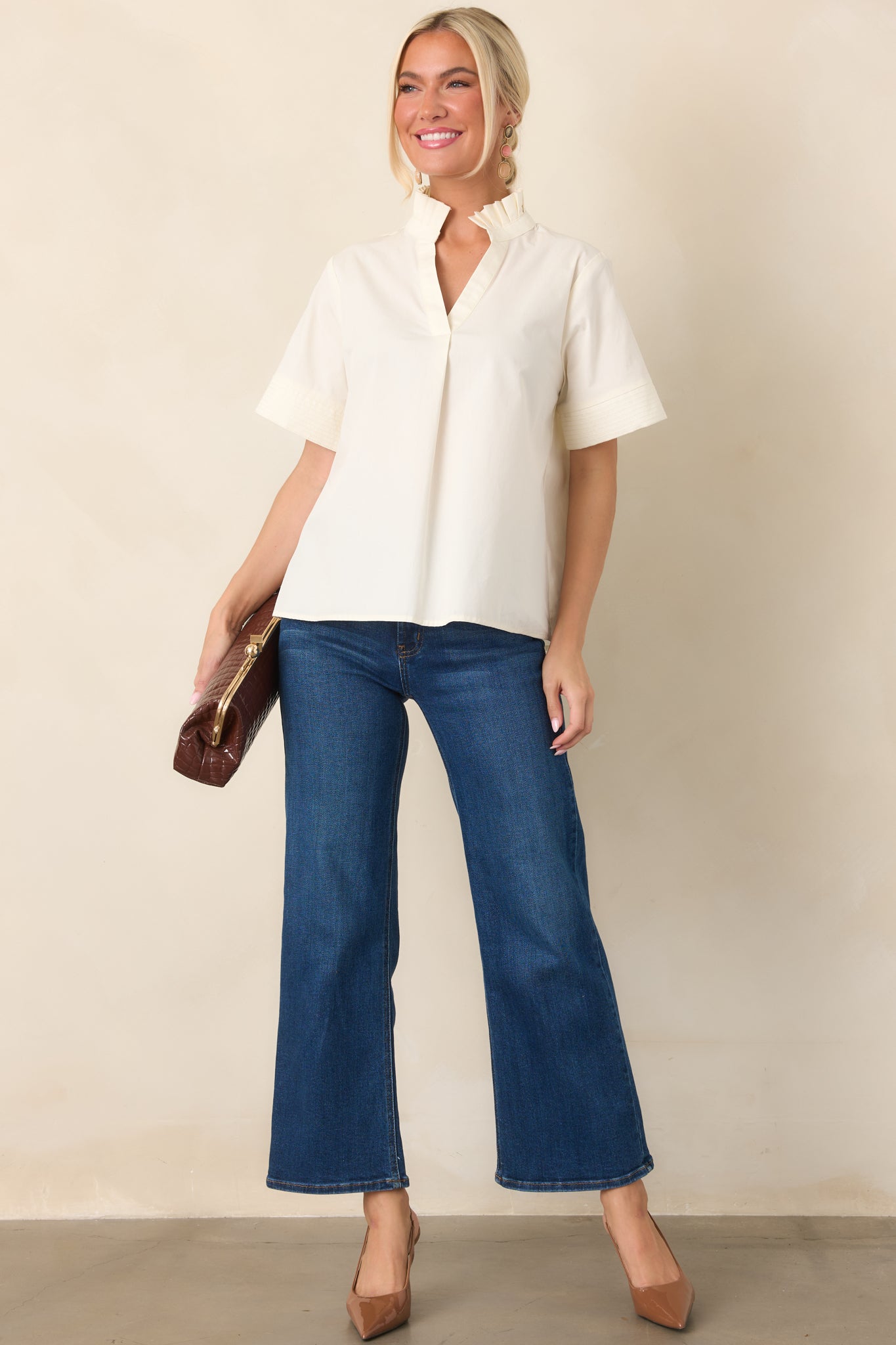 Dark wash jeans featuring a high waist, wide leg silhouette, slightly cropped length, belt loops, and practical front and back pockets.