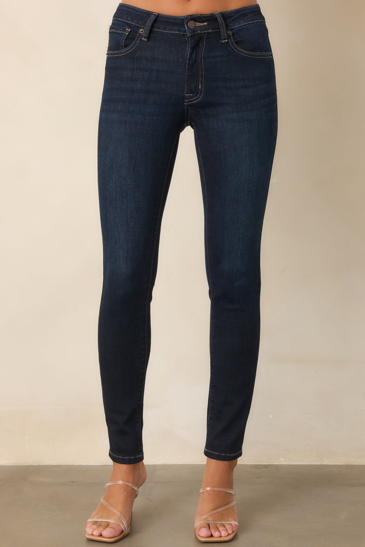 Dark wash jeans highlighting the classic five-pocket design and polished finish.