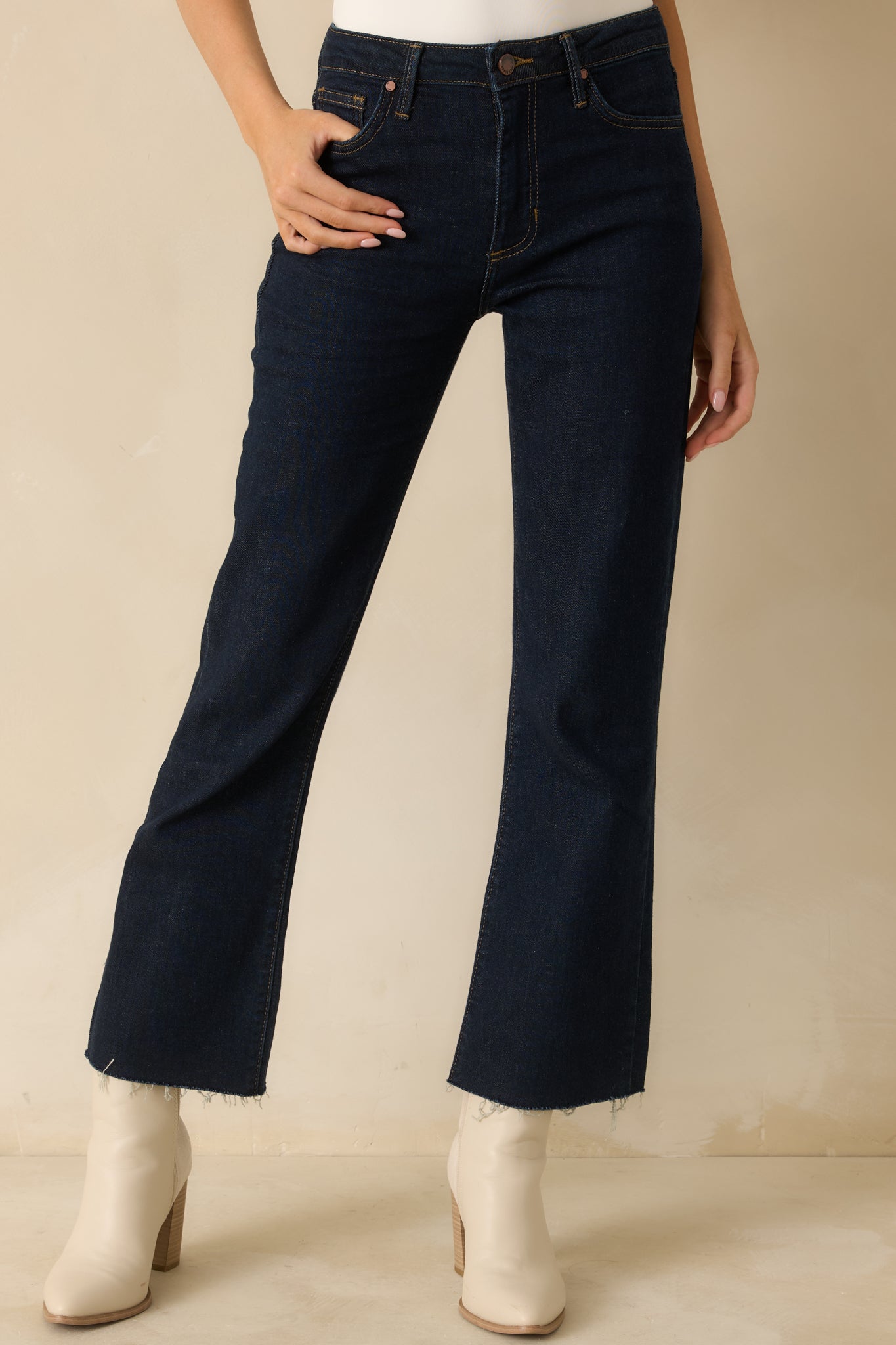 Detailed look at the upper front of the jeans featuring a structured high-rise waistband and sleek dark tone.