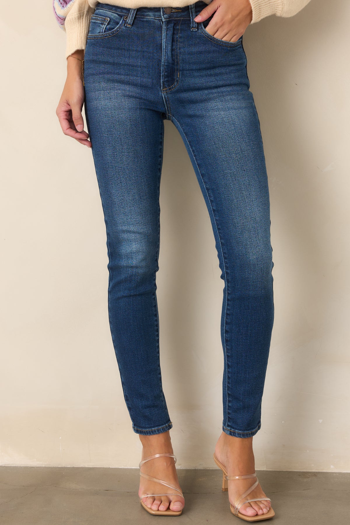 Dark wash jeans featuring a streamlined fit through the hips and thighs.