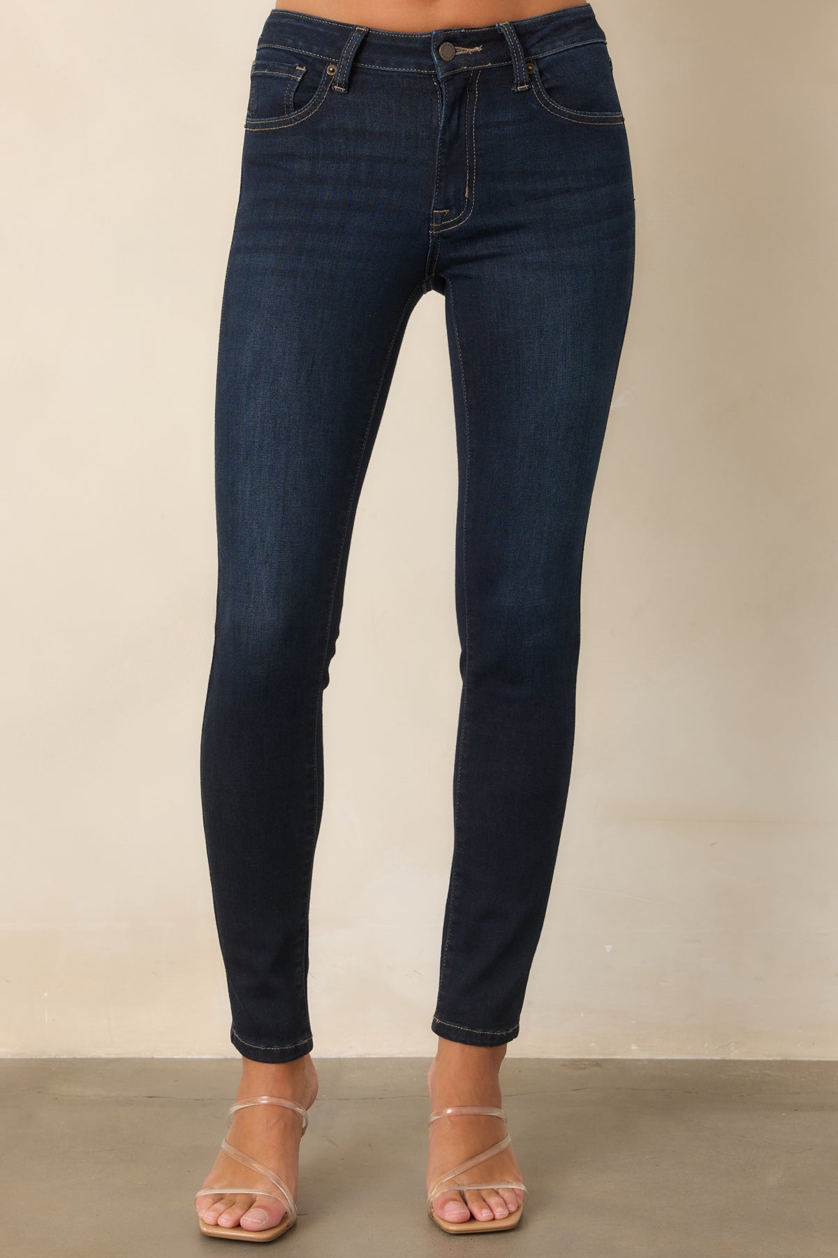 Dark wash stretch jeans with a sleek close-fitting shape and contrast stitching.