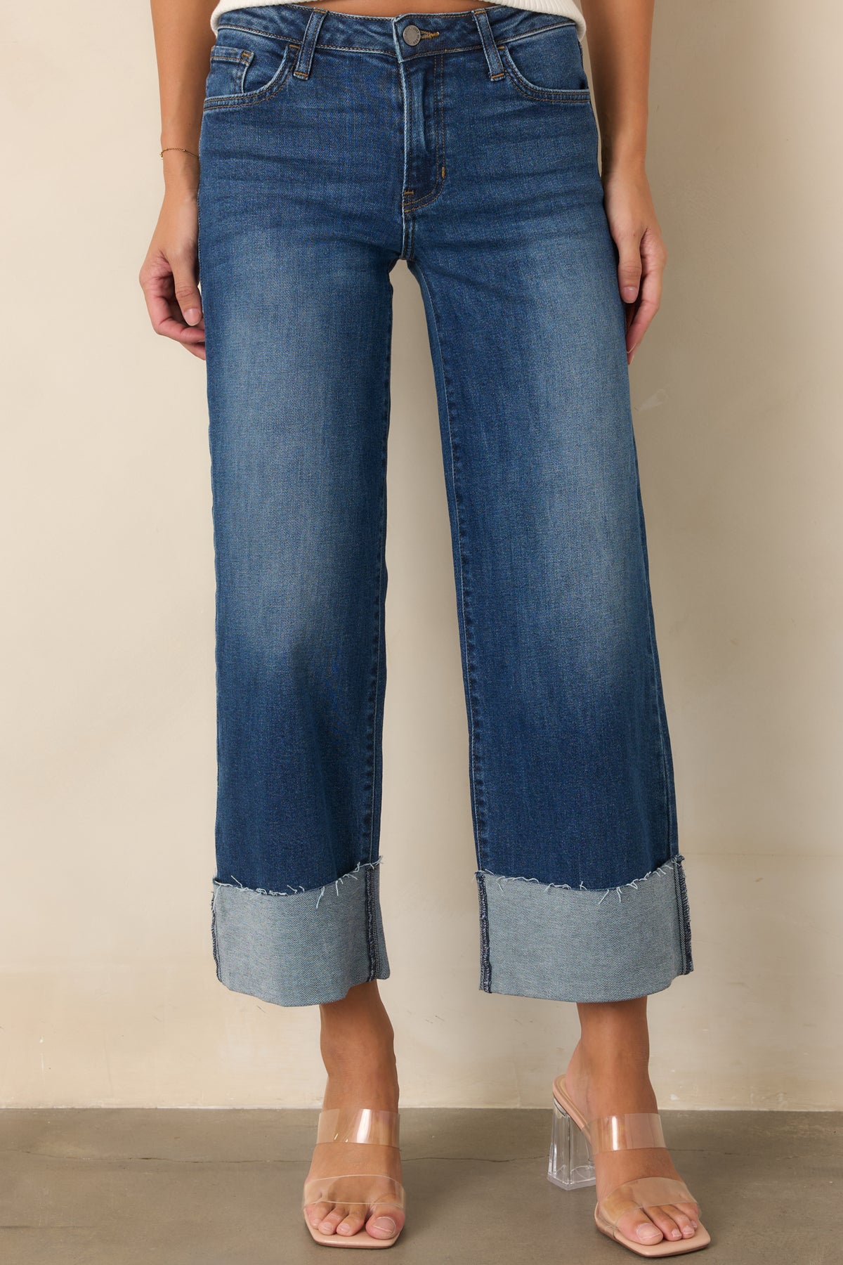 Dark wash wide-leg jeans highlighting the oversized cuffed hem and relaxed shape.