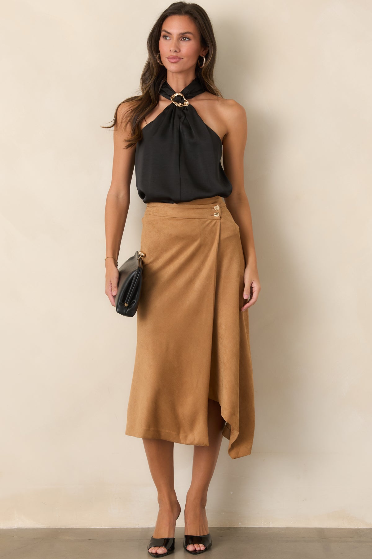 Decorative ring detail creates a distinctive focal point at the neckline of this sleeveless top.