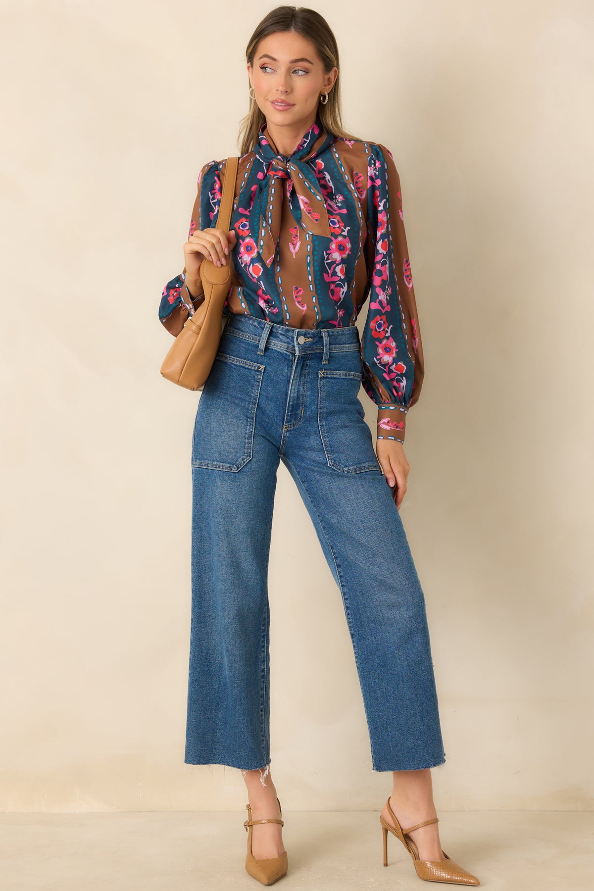 Deep blue and caramel blouse with colorful floral accents, a relaxed silhouette, and voluminous long sleeves.