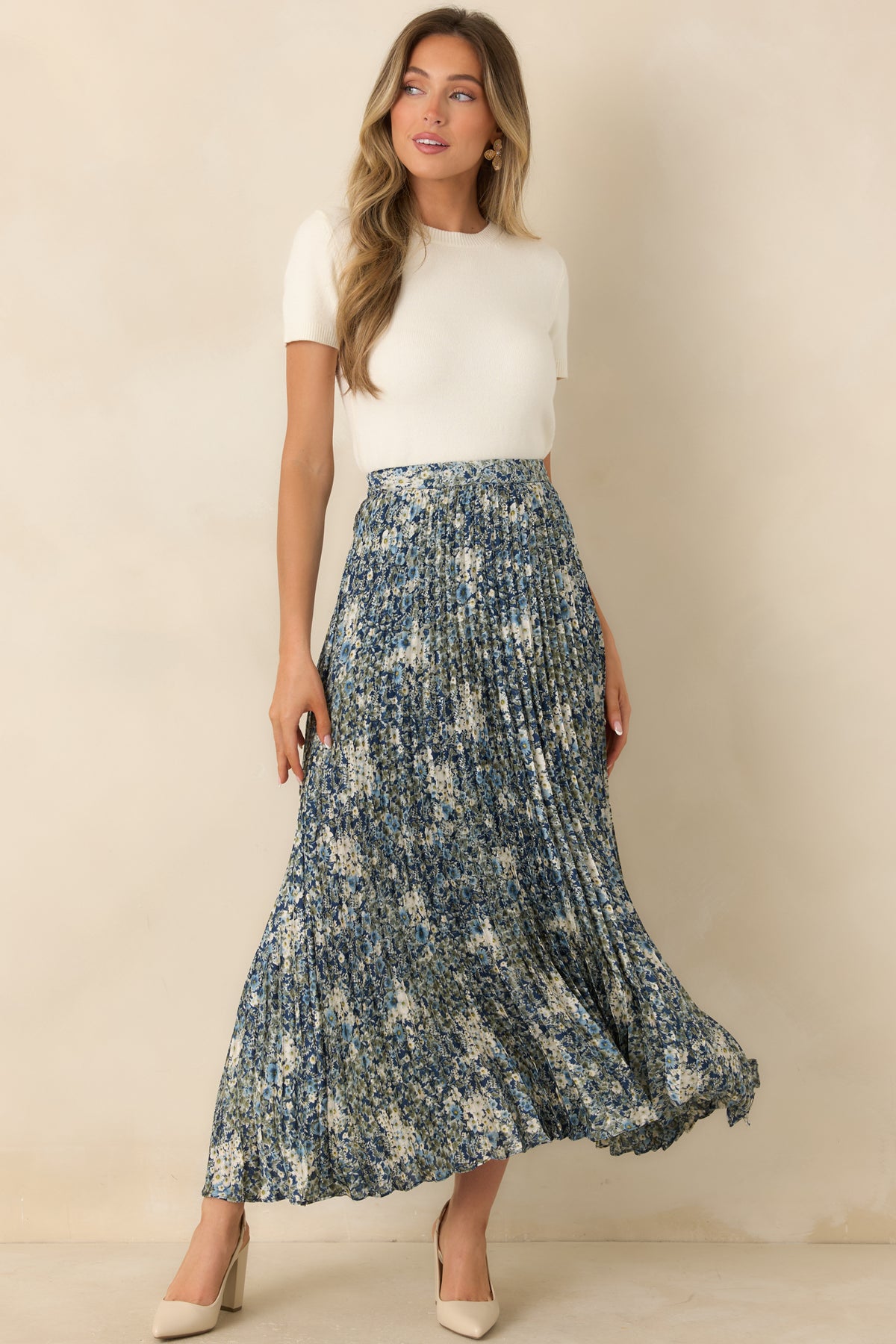 Deep blue floral maxi skirt with ivory, soft blue, and muted olive blooms and fine accordion pleats.
