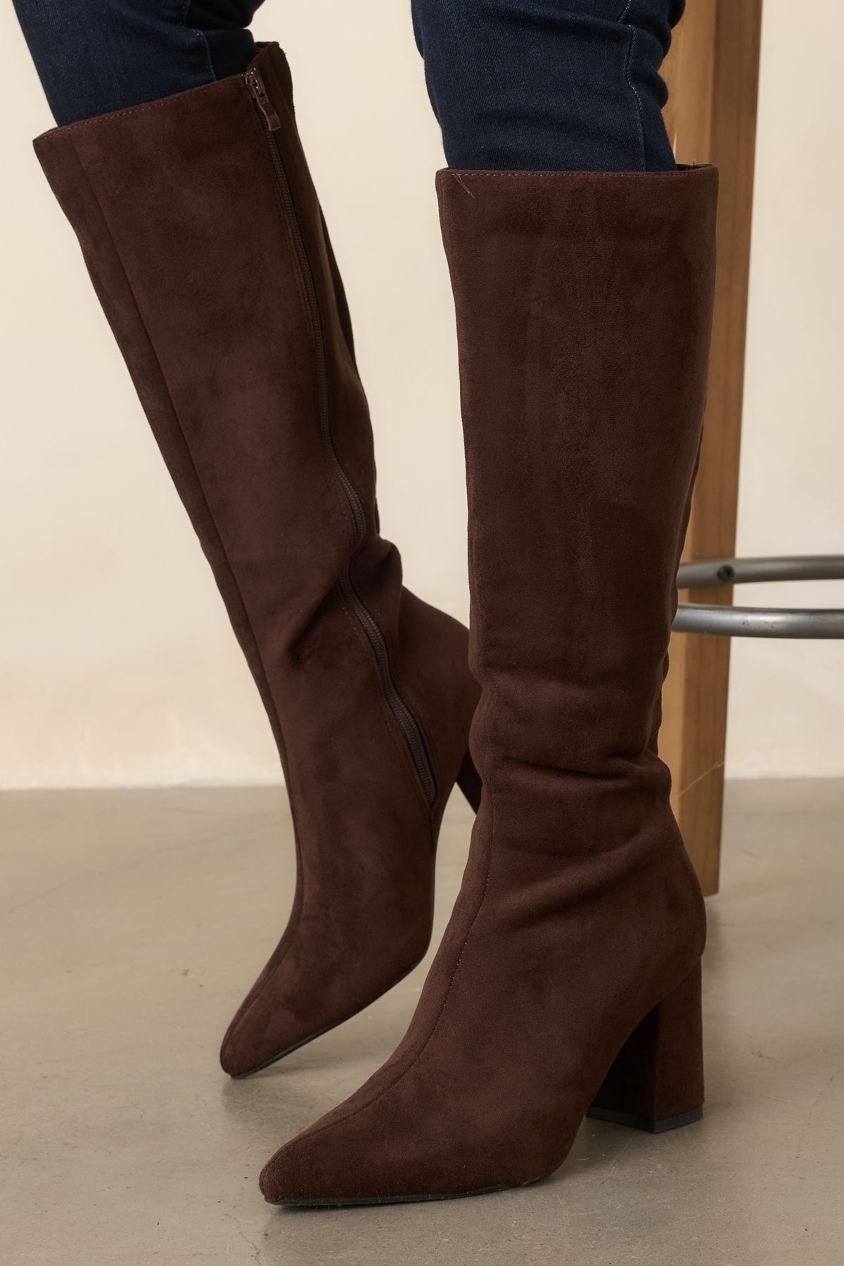Deep brown tall boots with a pointed toe, fitted knee-high shaft, and covered block heel.