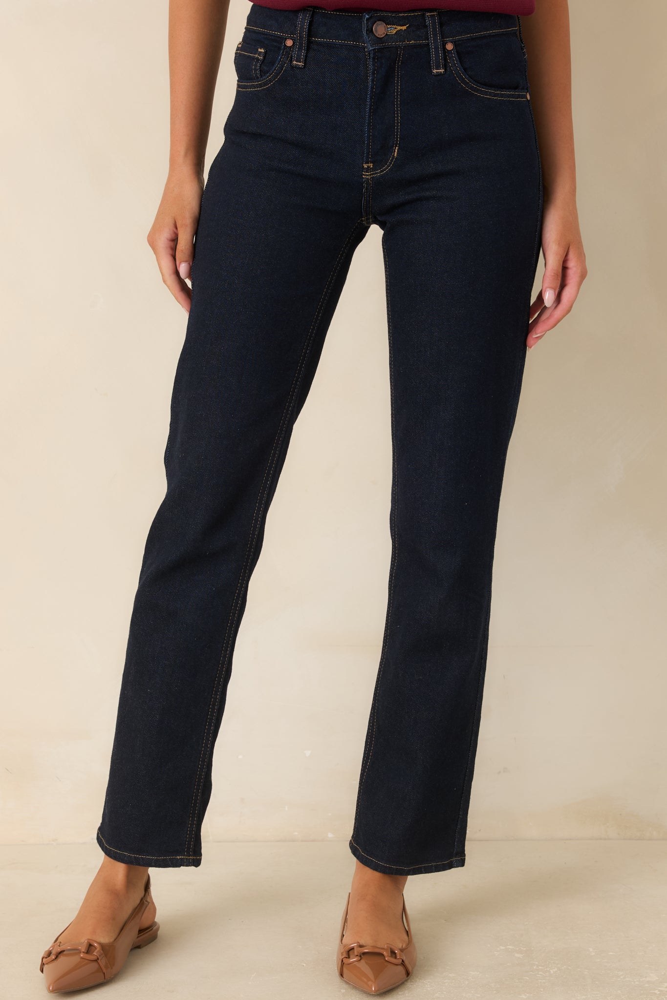 Close view of the deep indigo denim highlighting the rich color and classic five-pocket construction.