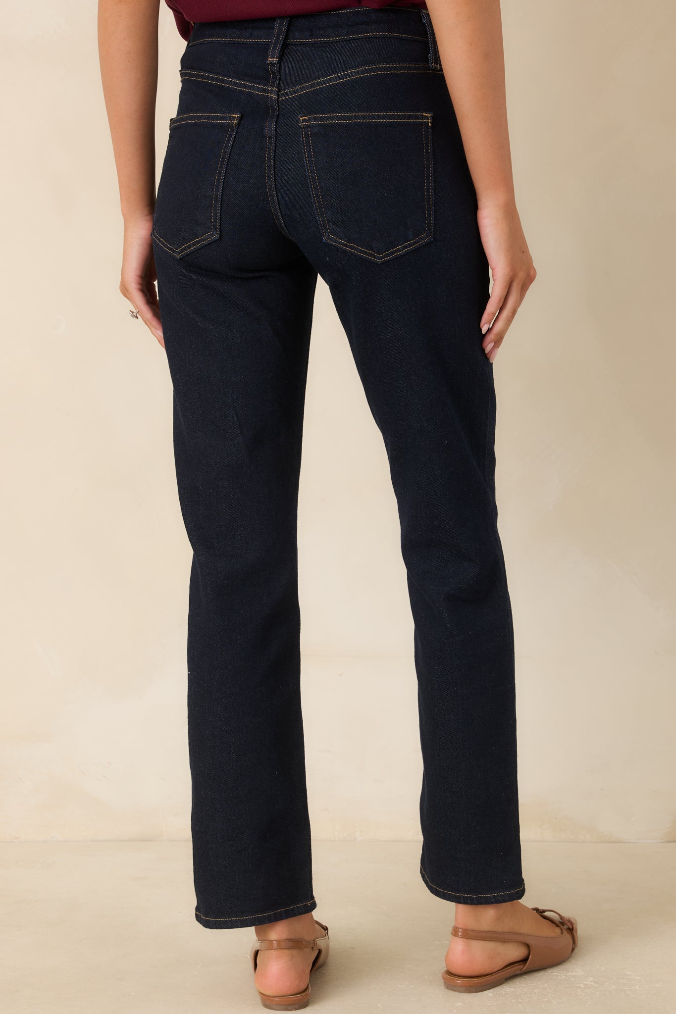 Back view of the deep indigo jeans featuring a straight-leg fit, functional back pockets, and a clean silhouette.