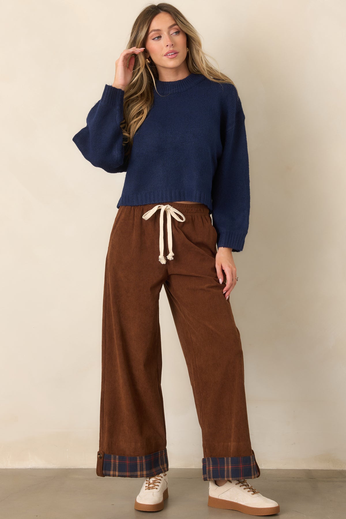 Deep navy knit pullover with a relaxed boxy silhouette, dropped shoulders, roomy long sleeves, and ribbed trim.