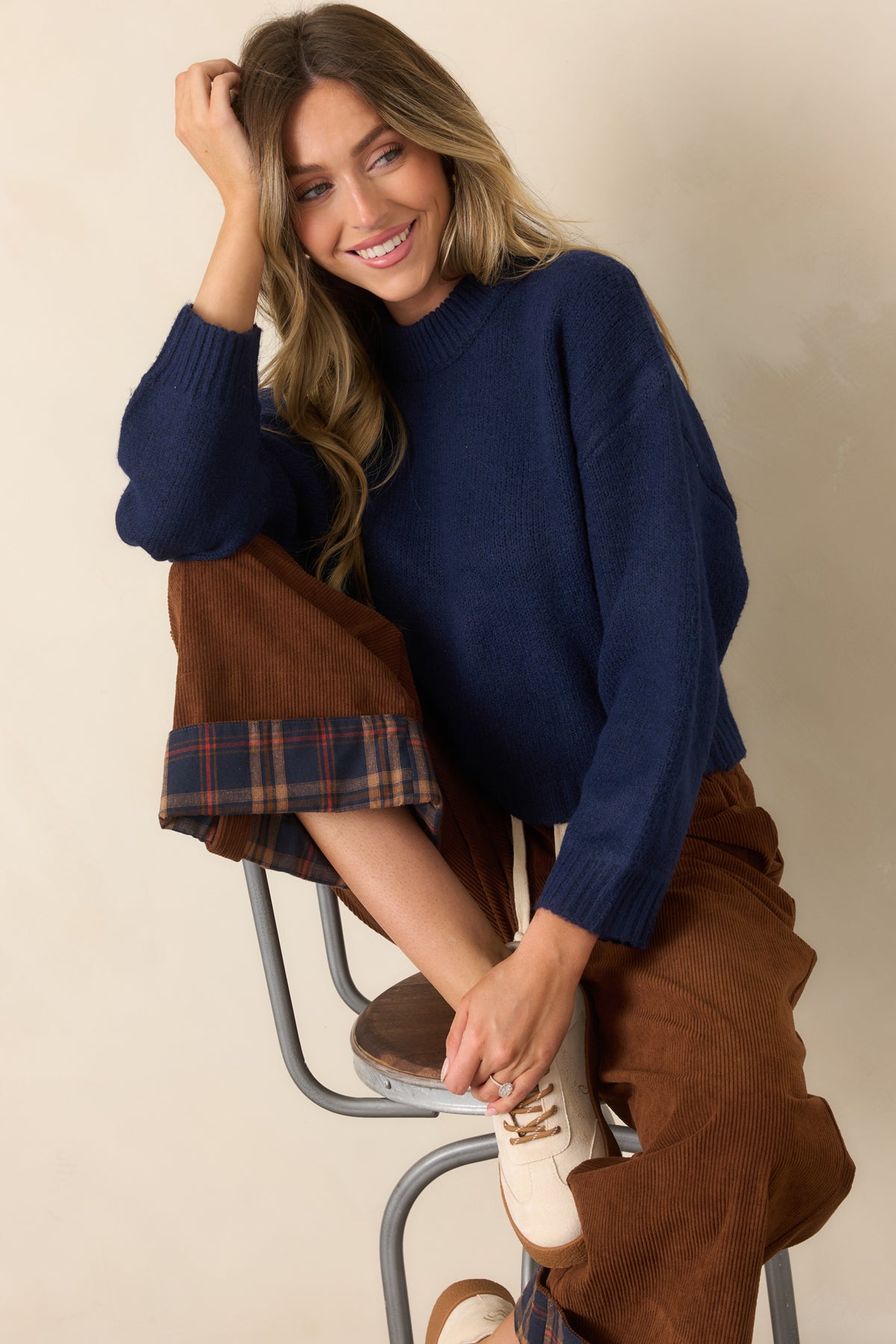 Deep navy knit top showcasing the oversized sleeves and softly structured boxy shape.