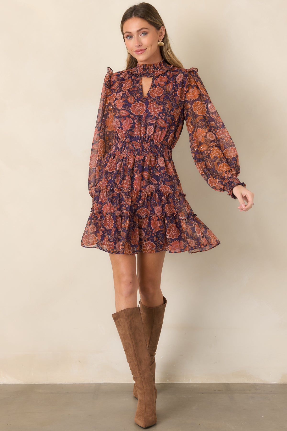 Deep plum floral mini dress featuring a sheer overlay, smocked high neckline, puffed long sleeves, and tiered skirt.