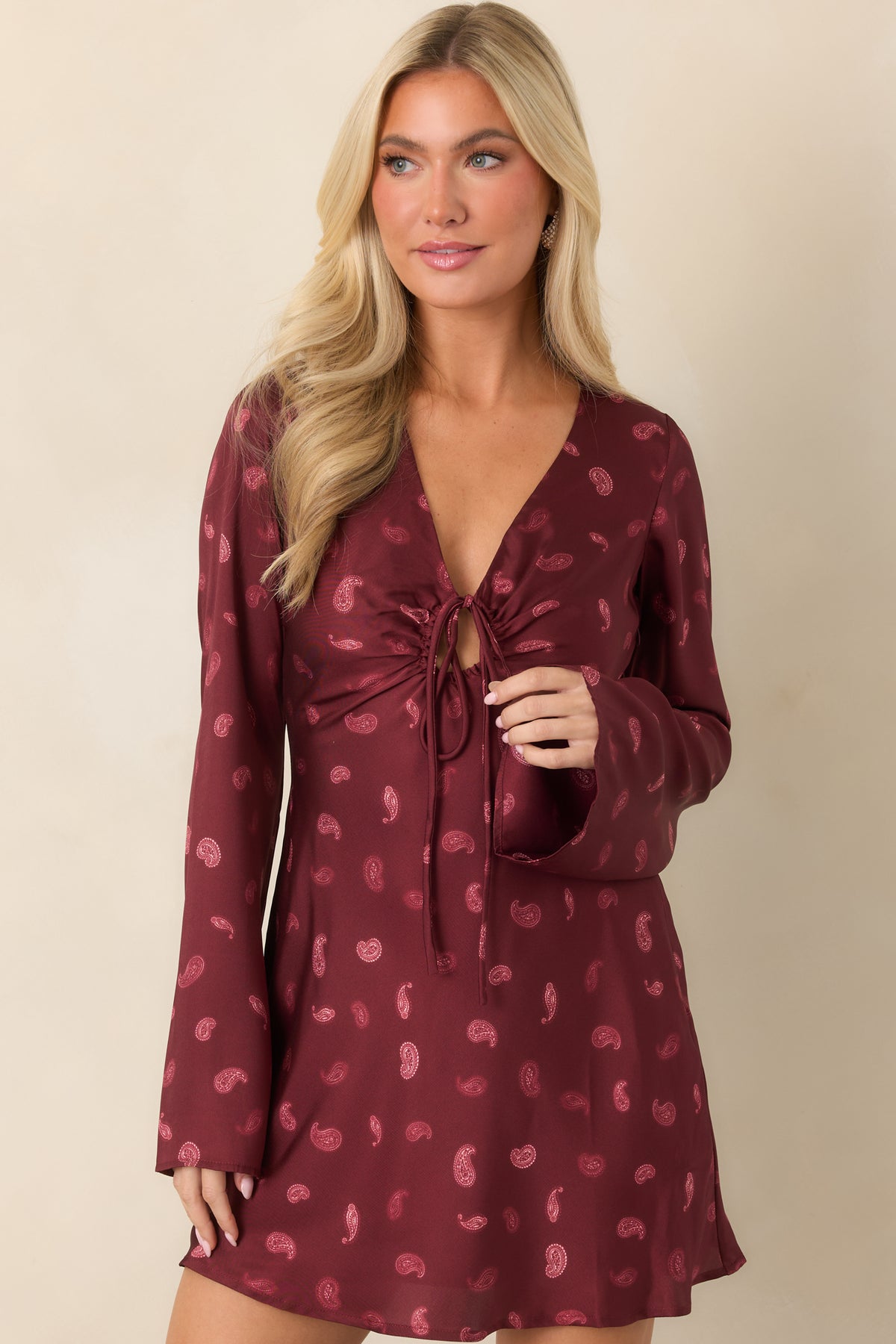 Deep wine satin dress highlighting the tonal paisley print and smooth finish.