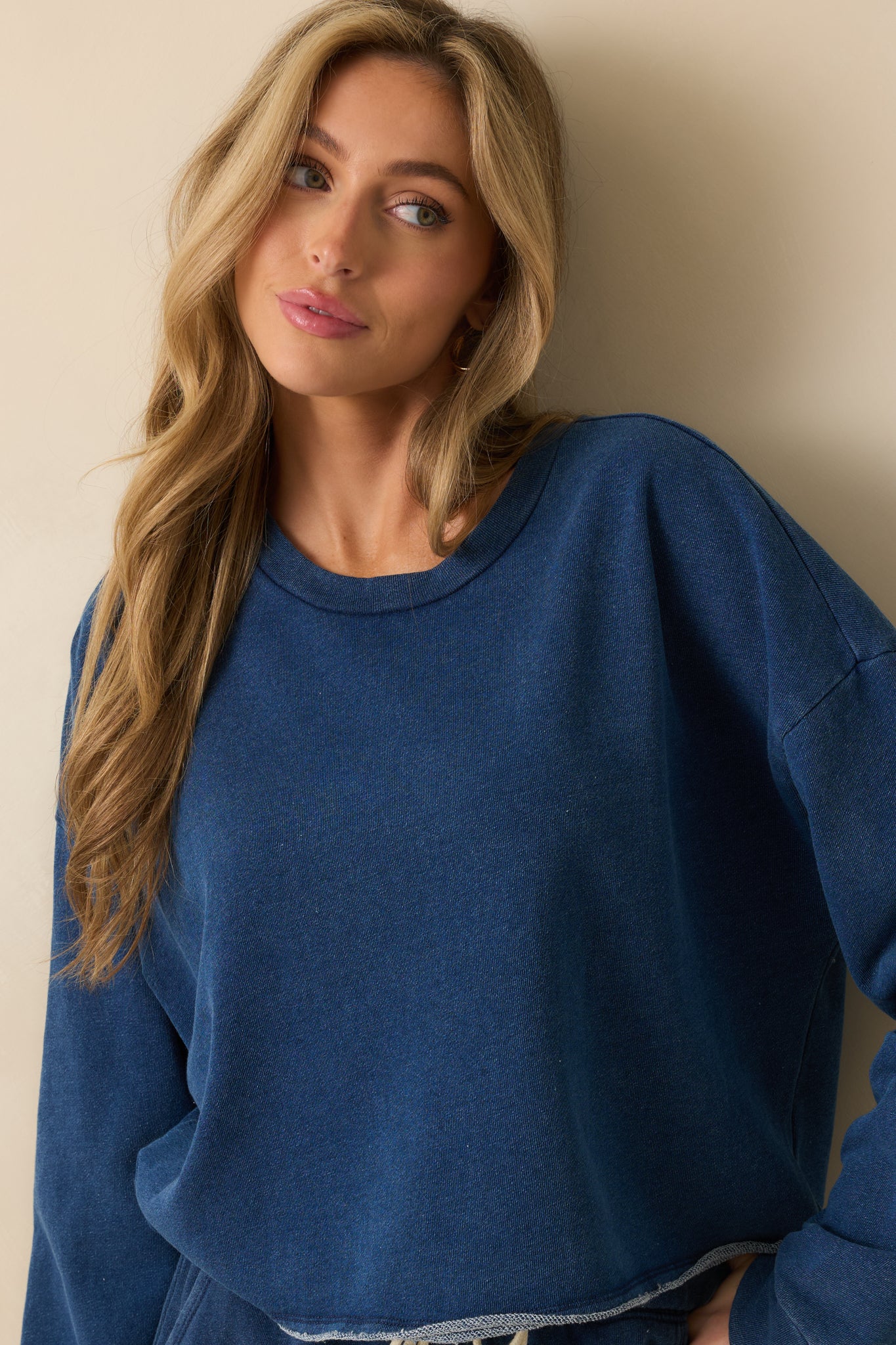 Cropped front view emphasizing the raw-edge hem and relaxed fit.