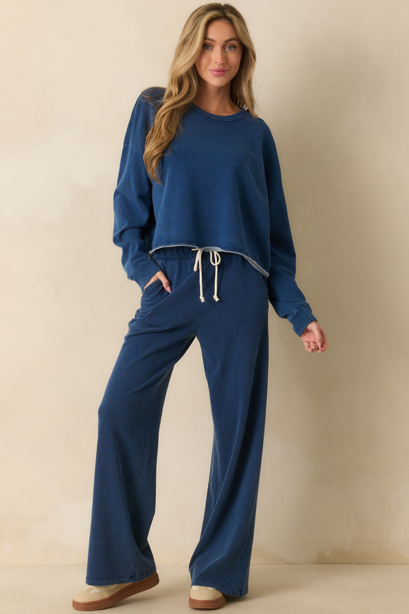 Long-sleeve sweatshirt highlighting ribbed cuffs and smooth knit fabric.