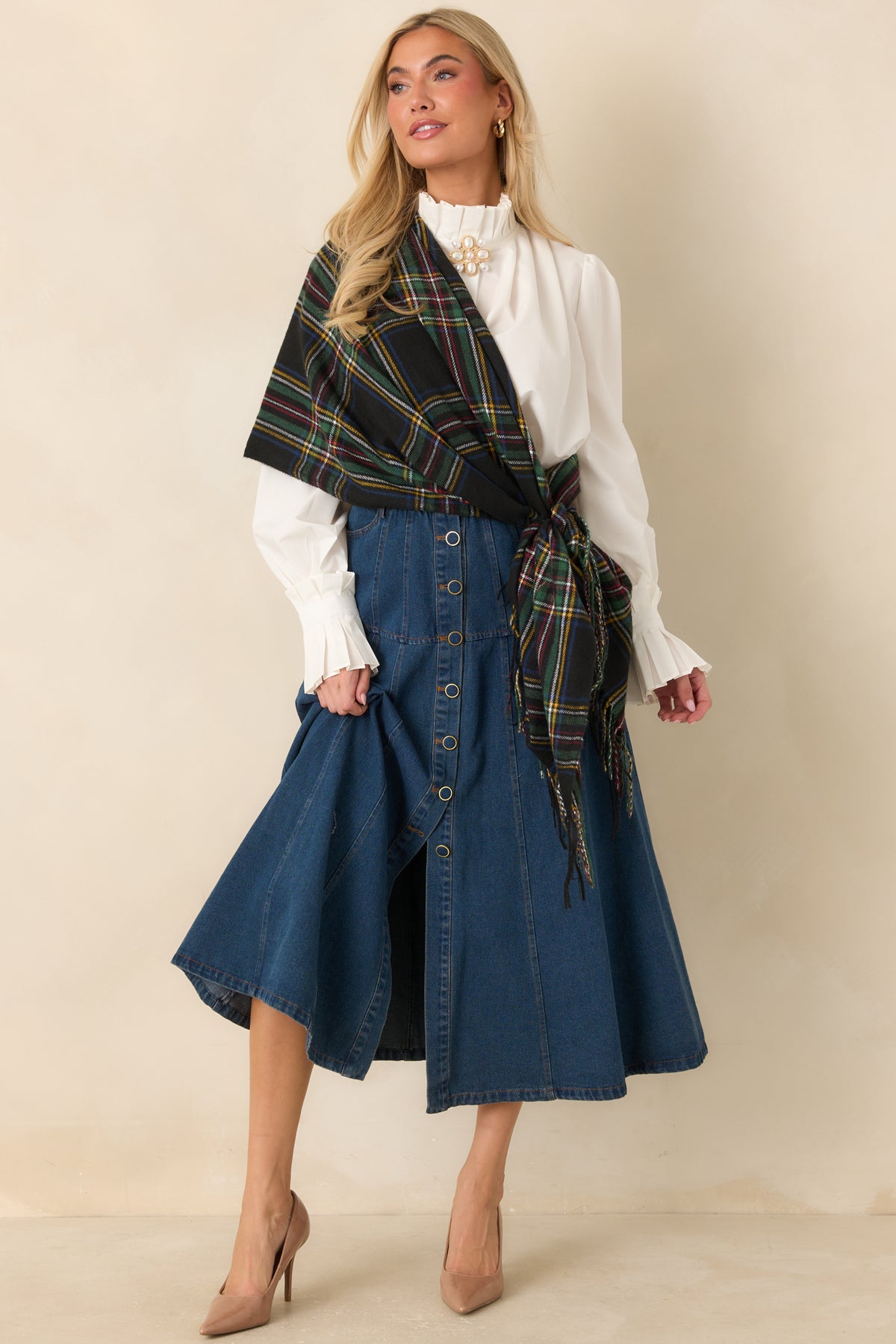 Denim midi skirt with a structured waistband, contrast stitching, and a gently widening hem.