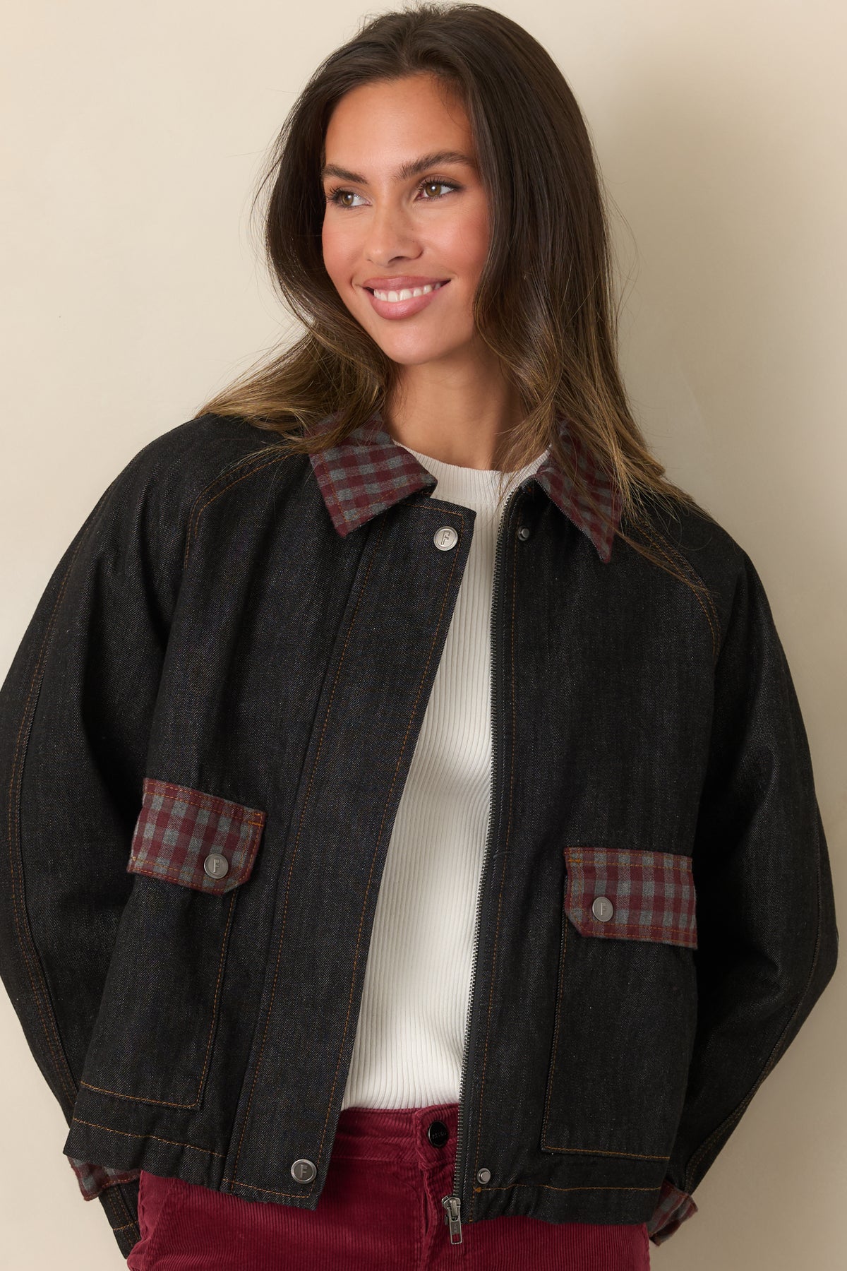 Denim jacket showcasing the oversized front pockets with contrasting stitching and gingham pocket flaps.
