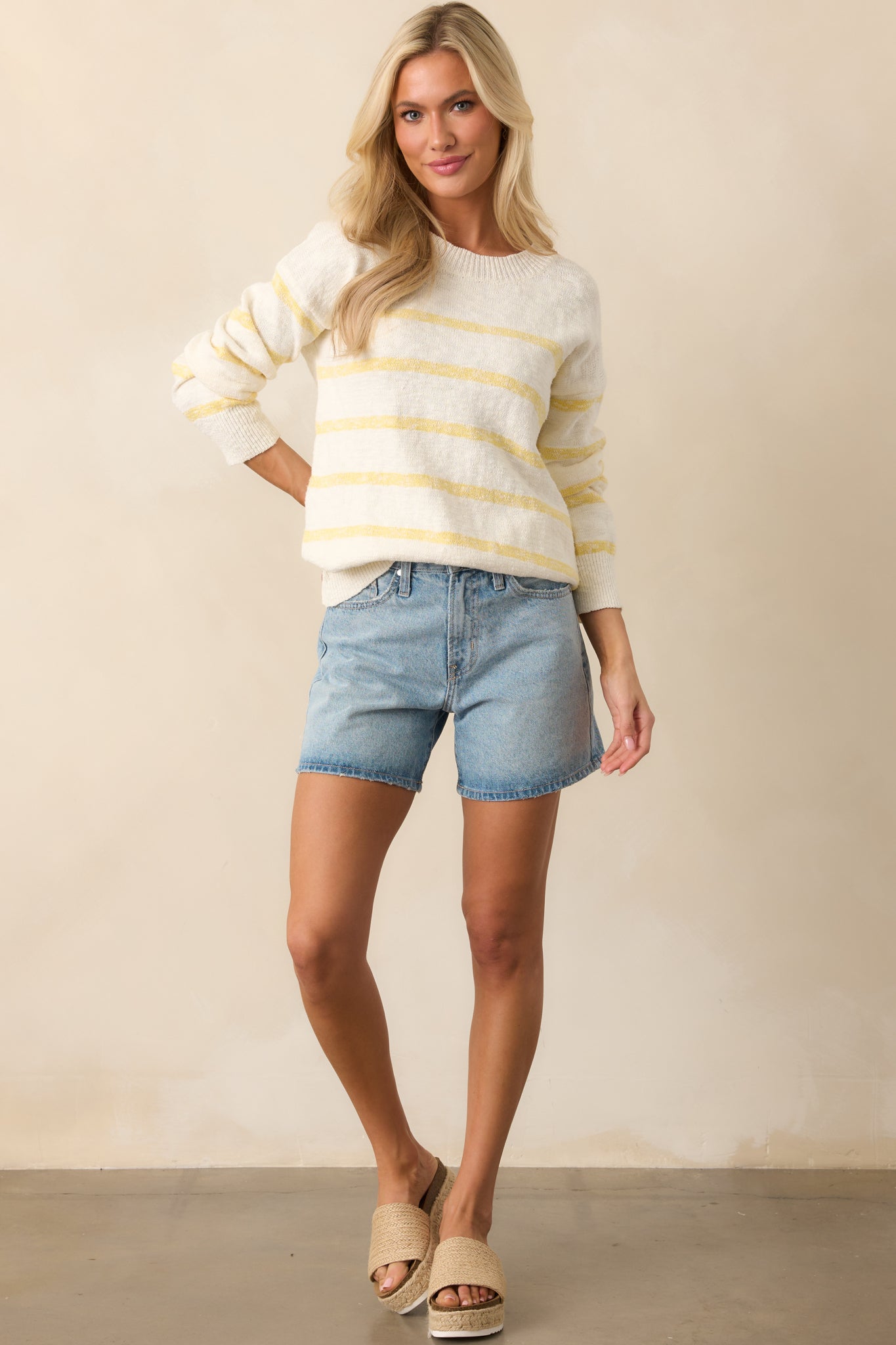 Casual high-waisted denim shorts in a light wash, designed with functional belt loops, a secure button-zipper closure, and a slightly relaxed fit.
