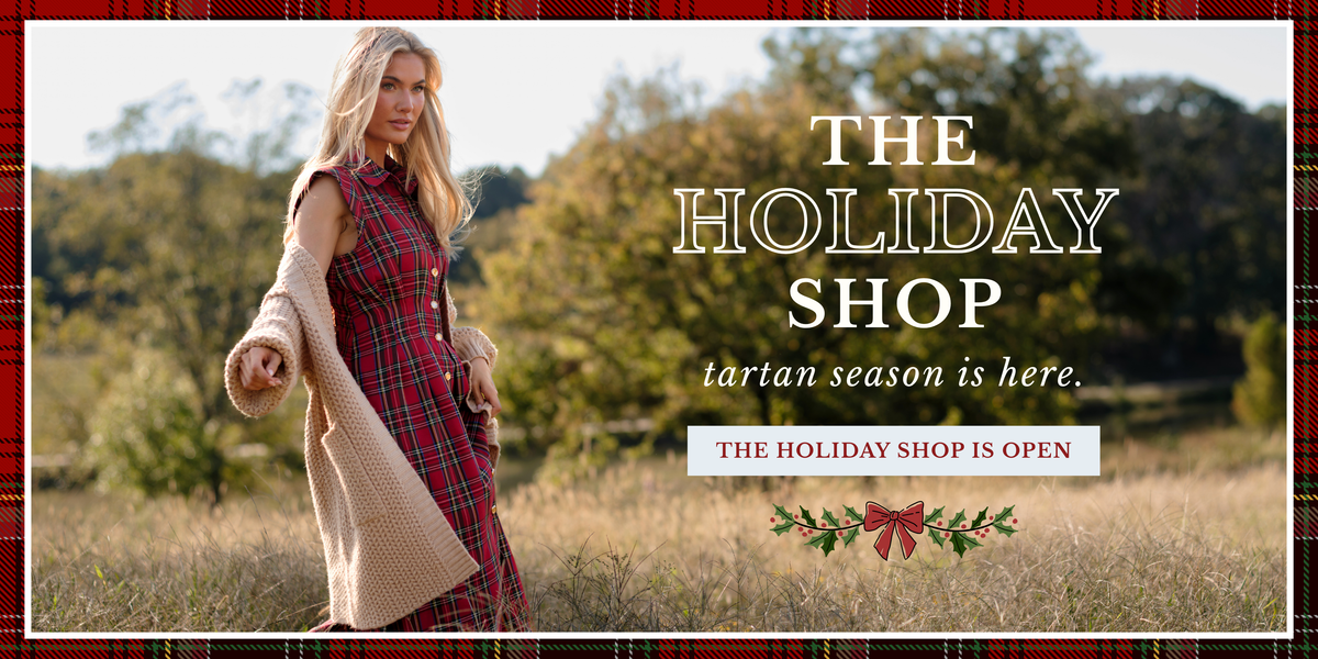 Model wearing a red tartan midi dress. Text reads: "The Holiday Shop. Tartan season is here."