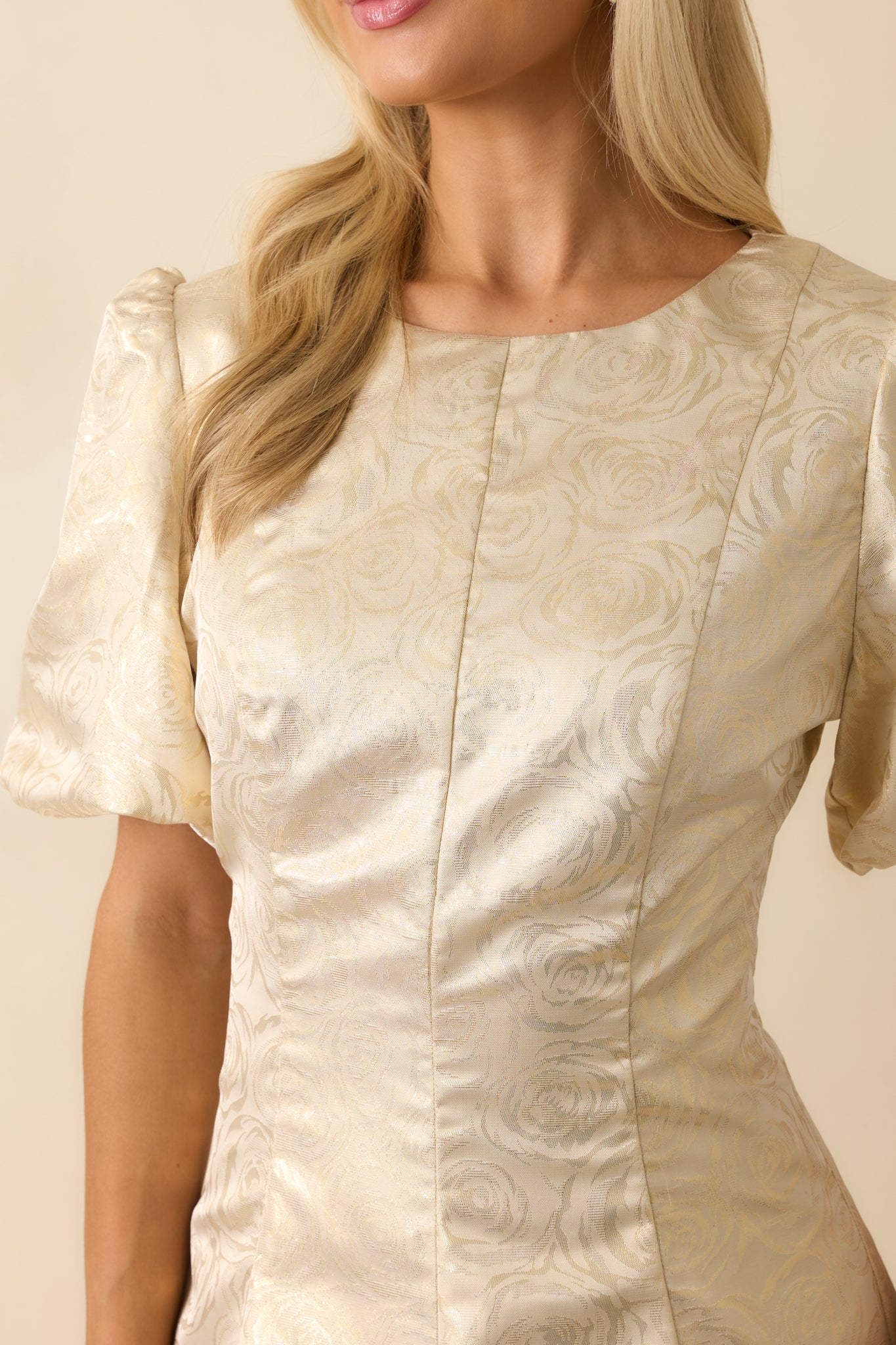 Detail close-up capturing the intricate floral jacquard weave and soft champagne tone.