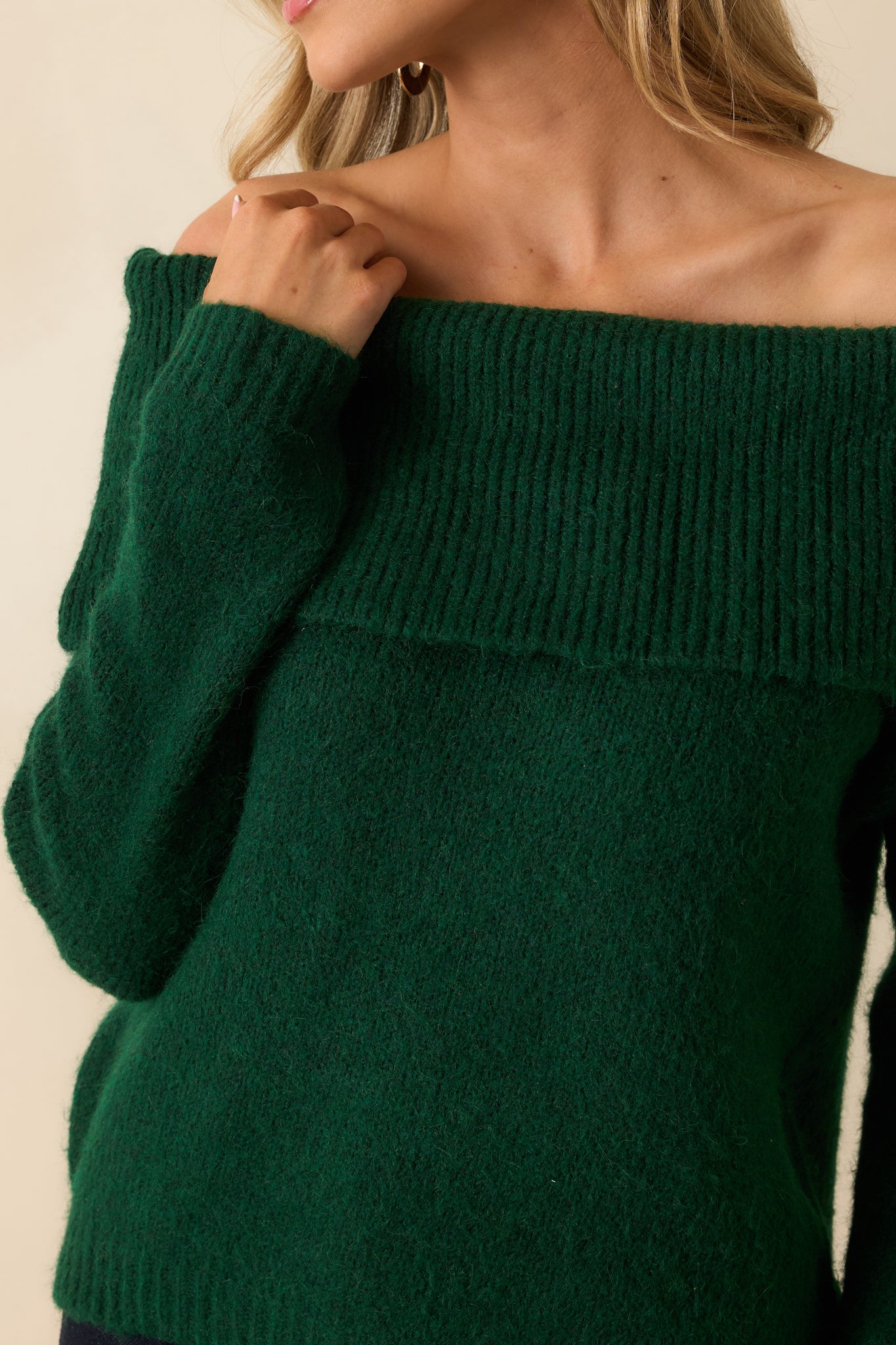 Detailed shot of the emerald sweater showcasing the wide foldover neckline, fuzzy knit texture, and ribbed trim.
