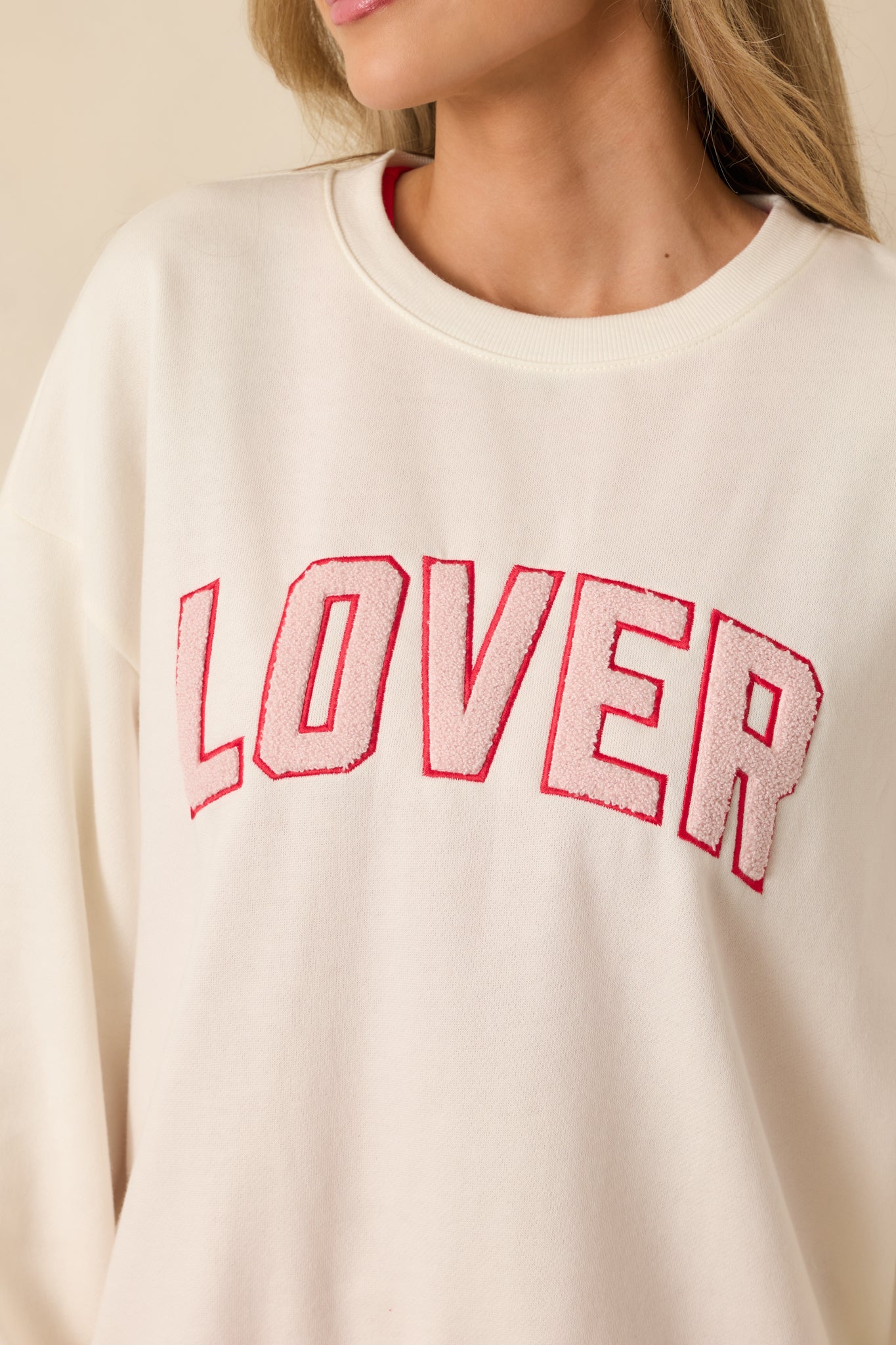 Close detail of the raised textured lettering and soft fleece fabric